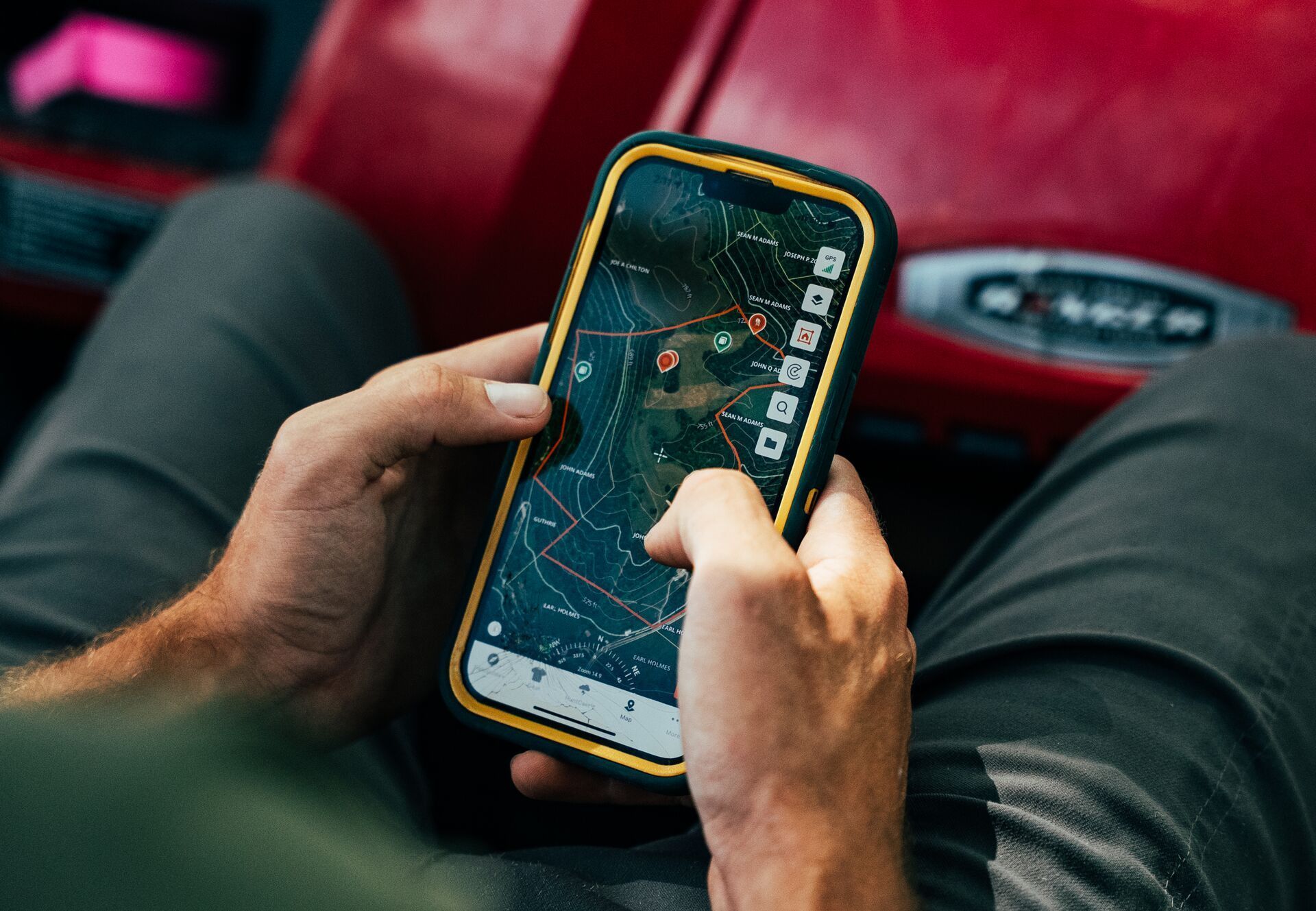 Close-up of someone using phone with HuntWise hunting app on screen.