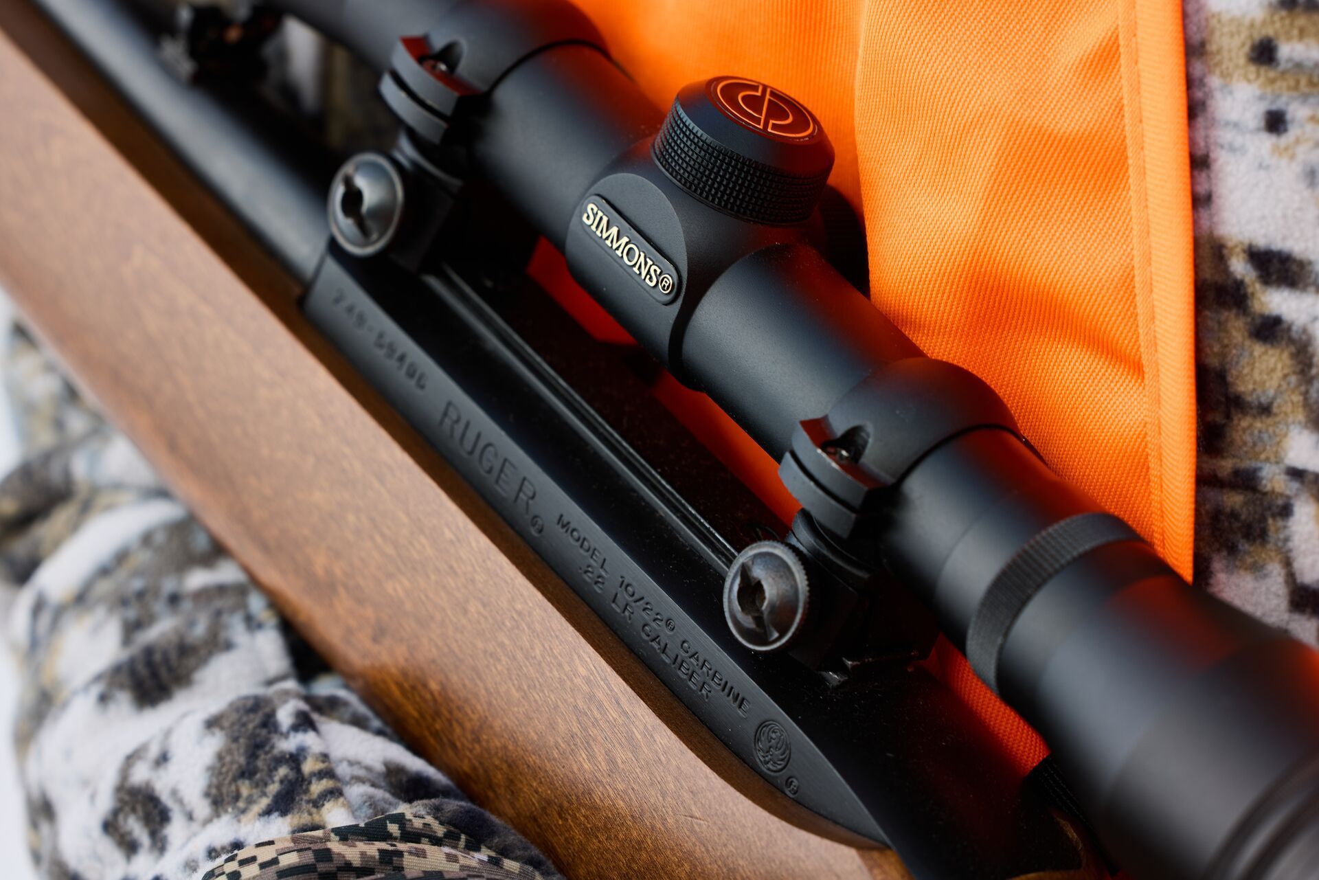 Close-up of hunter holding .22 rifle, best .22 caliber for small game concept.