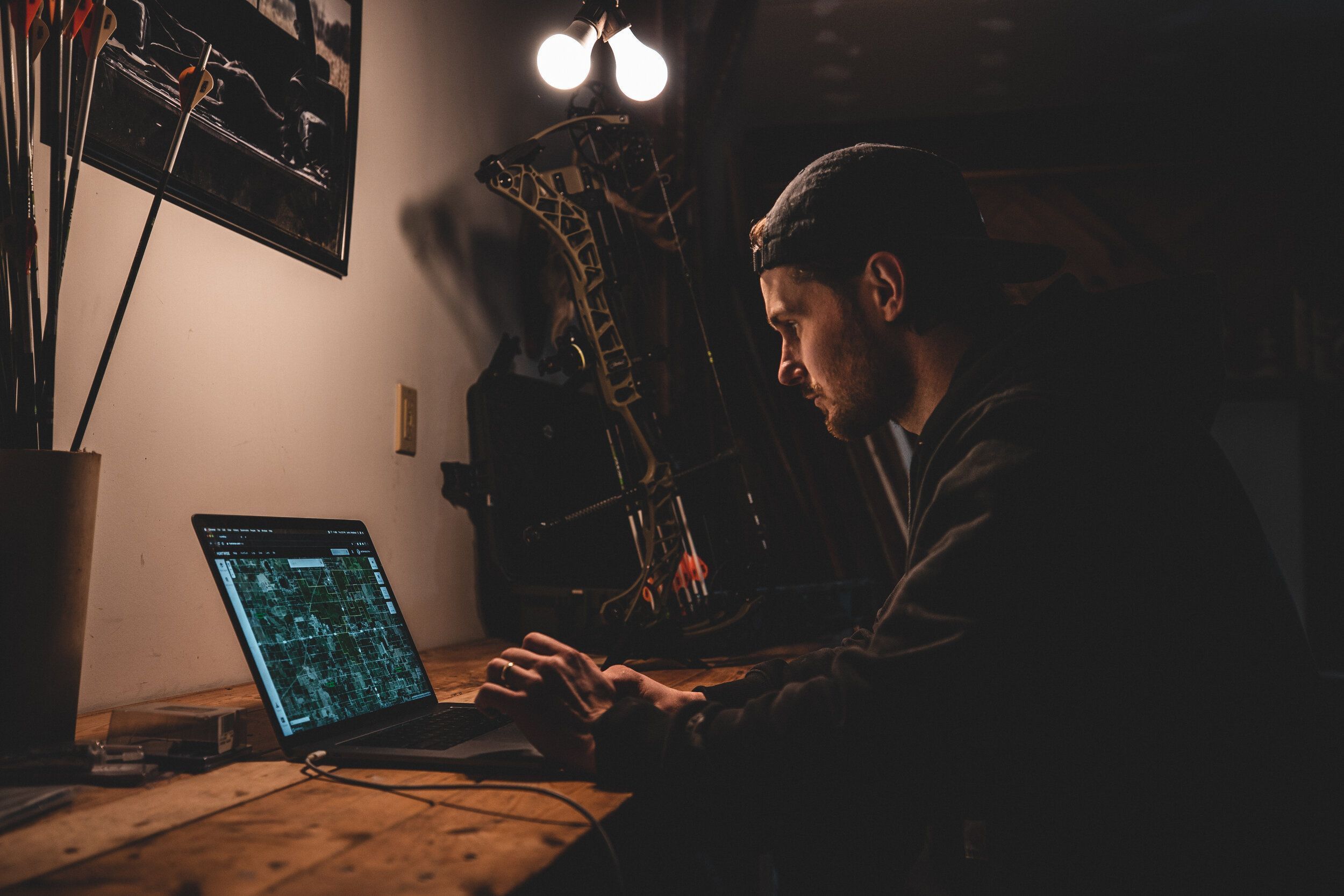 A hunter uses HuntWise on a desktop, using cellular trail cams and HuntWise concept.