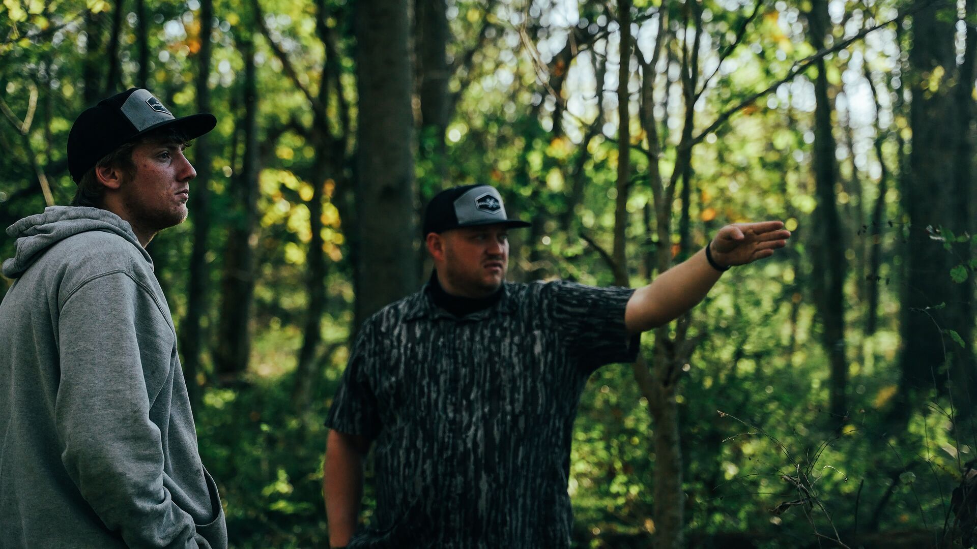 Two hunters in the woods talking, hunting permission private land concept. 