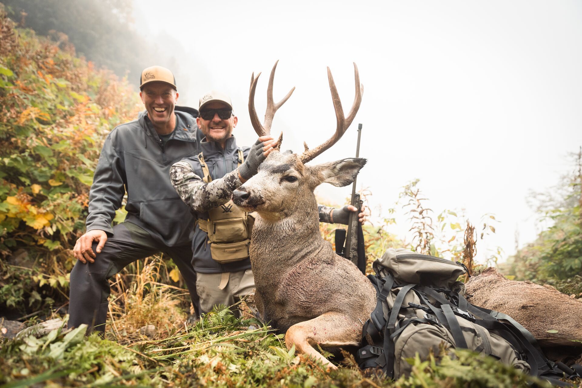 Hunters show off mule deer after hunt, mule deer hunting concept.