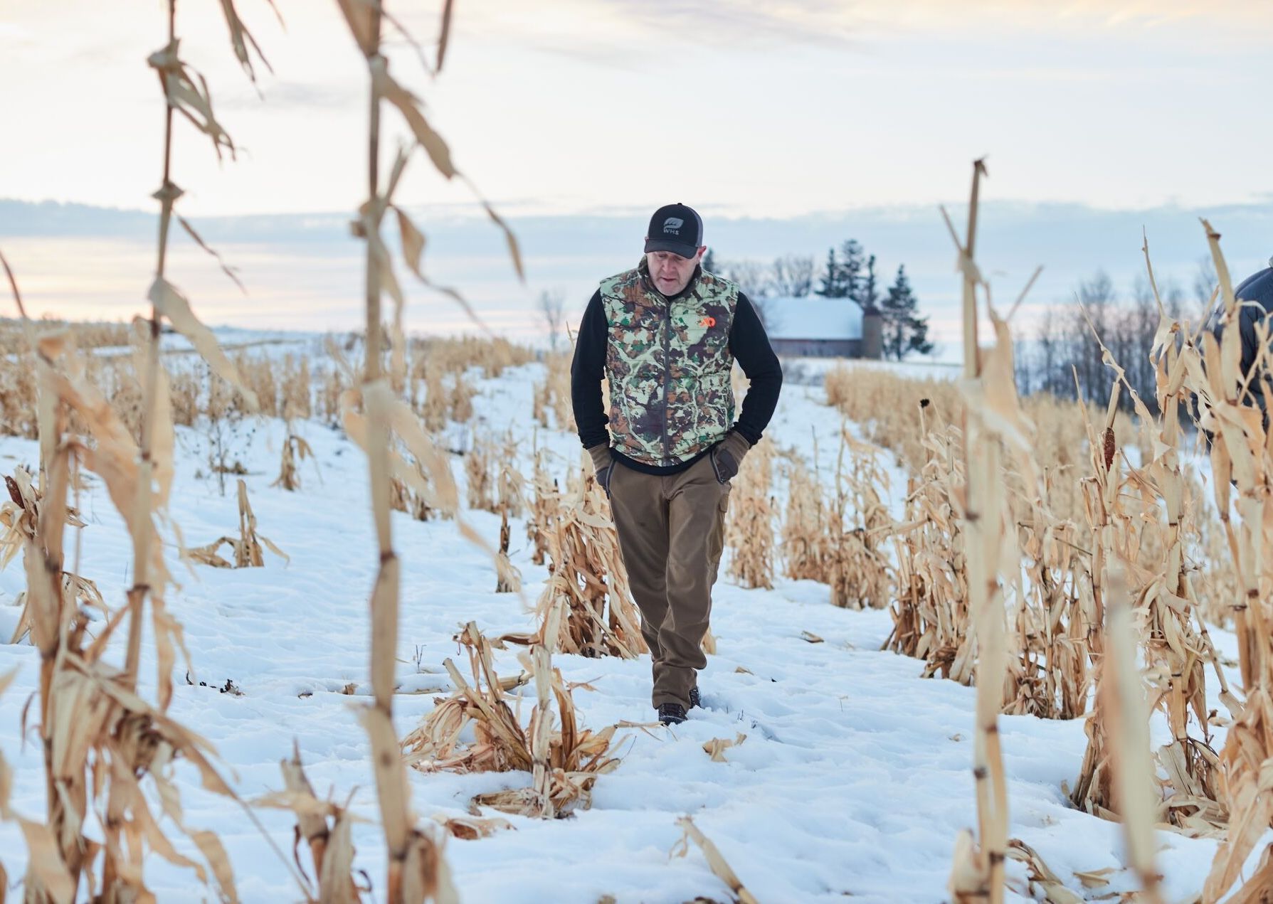Jeff Sturgis walks through a snowy field before a late-season hunt.