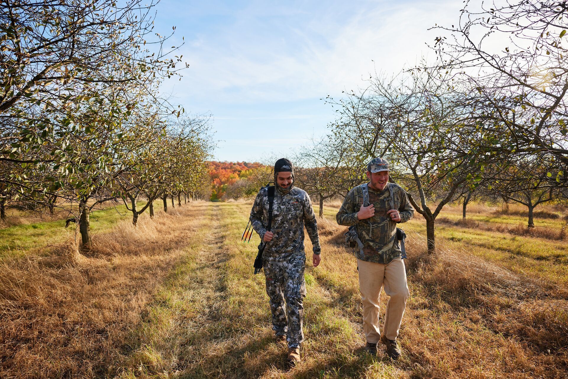 Two guys walking a trail for a hunt, where can I hunt deer concept.