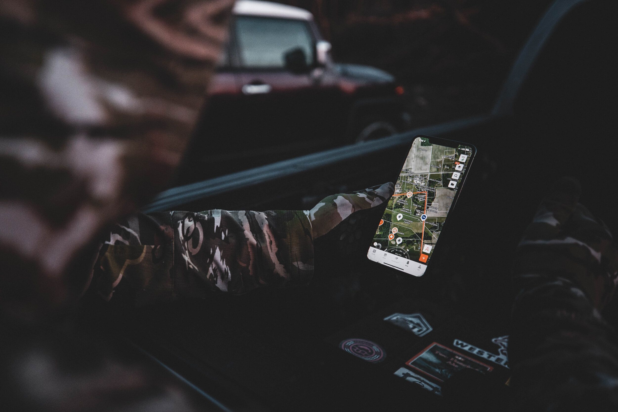 Hunter using the HuntWise app on a phone screen, how to find turkey hunting land concept.