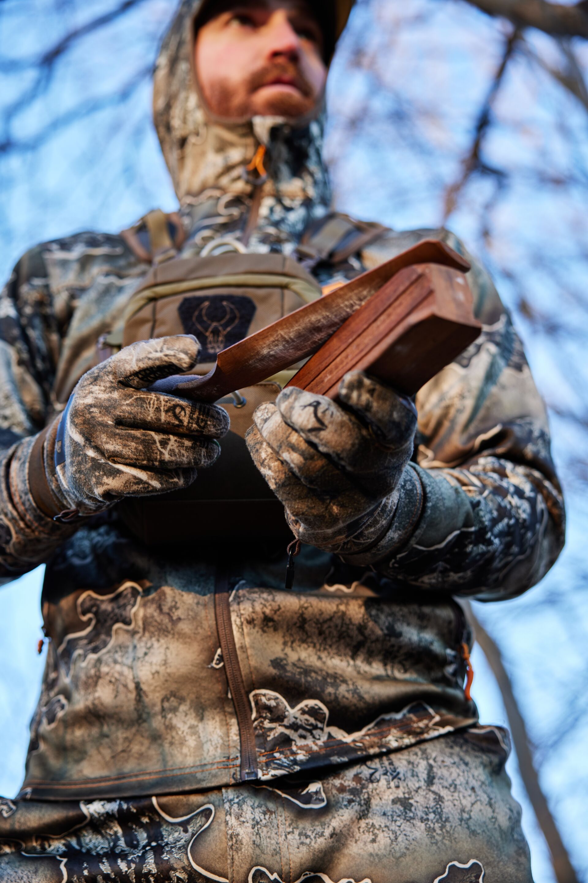Close-up of a hunter using a turkey box call, turkey calling basics concept.