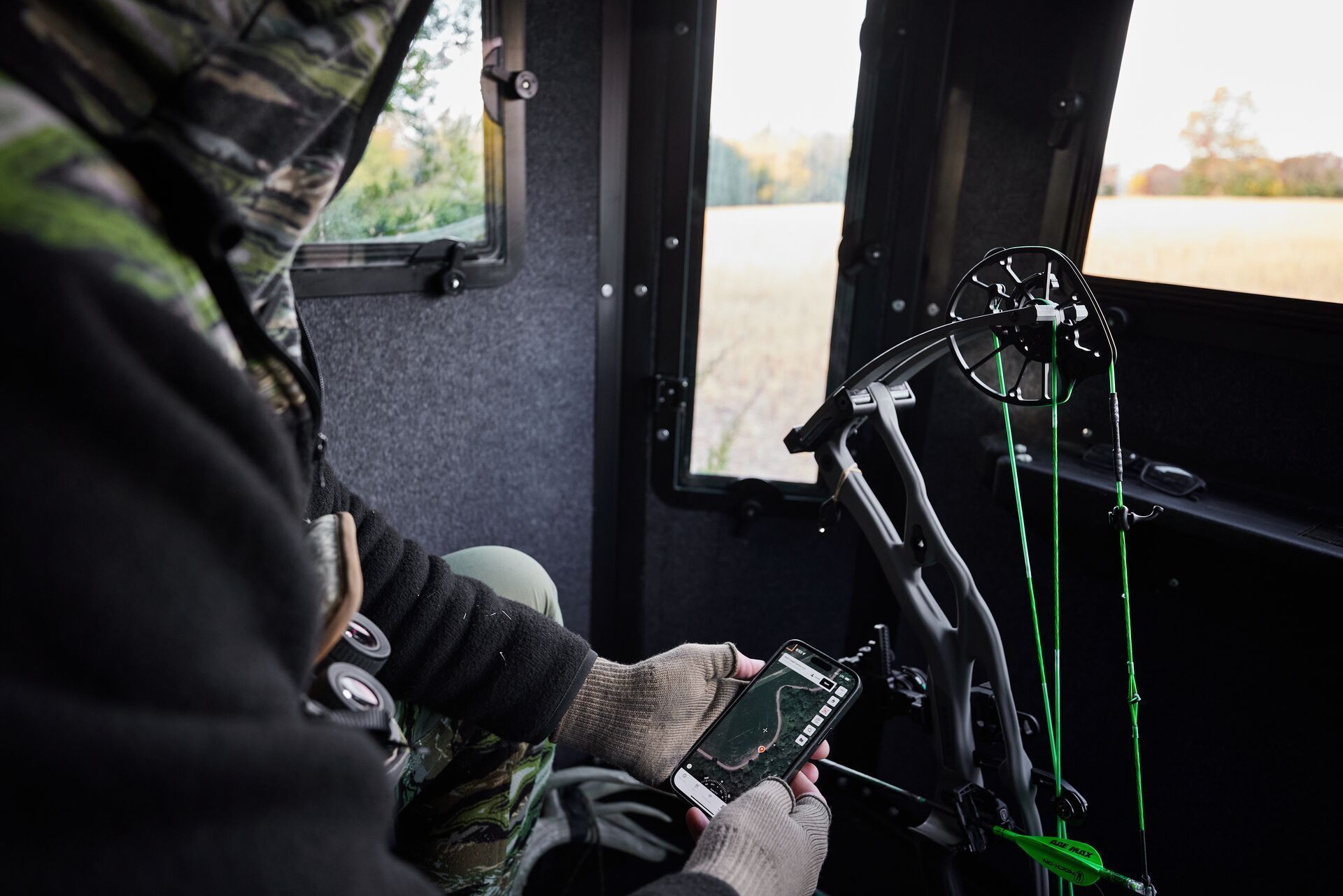 A hunter uses the HuntWise app while in a hunting blind.
