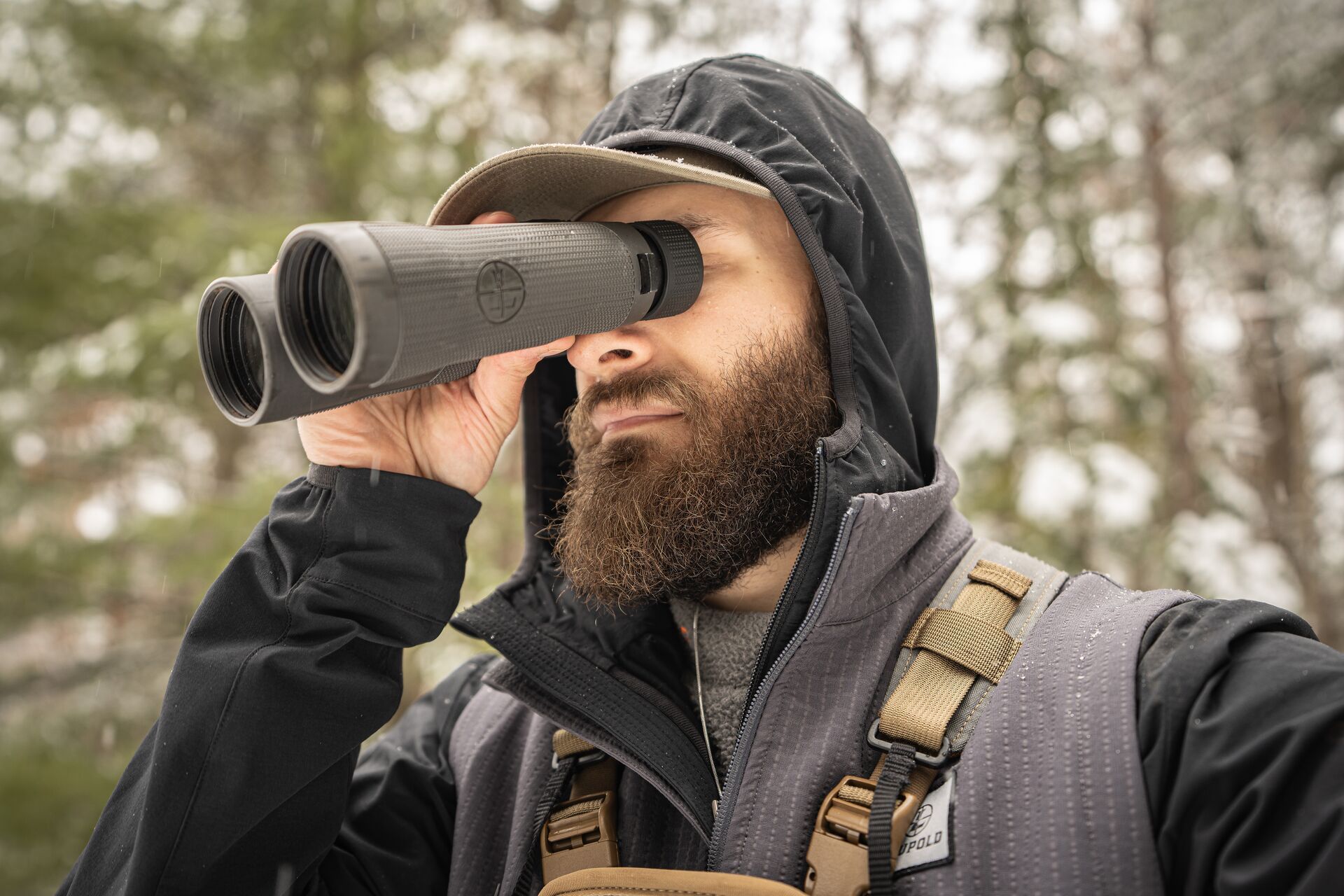 Hunter using binoculars, elk hunting gear concept.