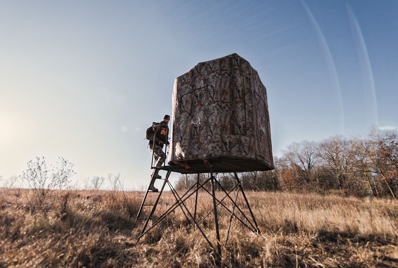 A hunter climbs into a hunting blind, Indiana hunting concept.