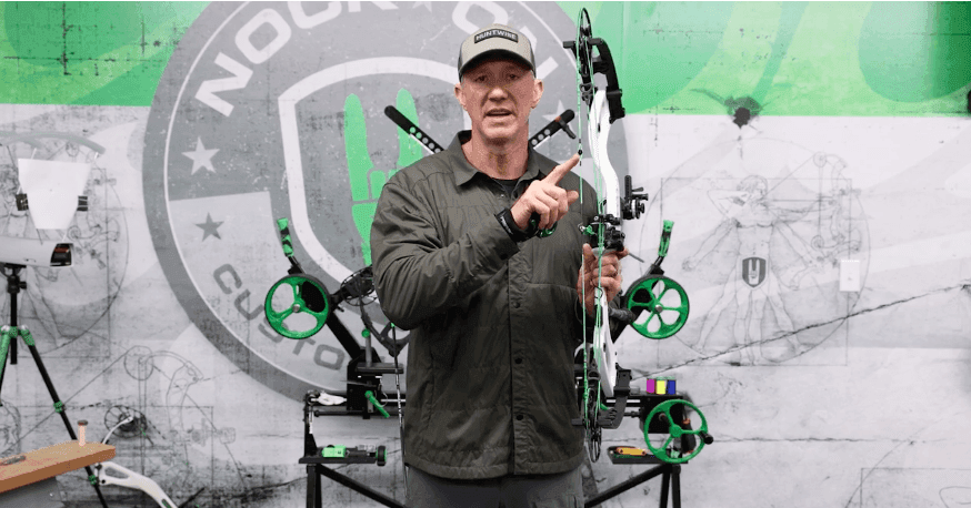 John Dudley shows the peep sight of a compound bow.