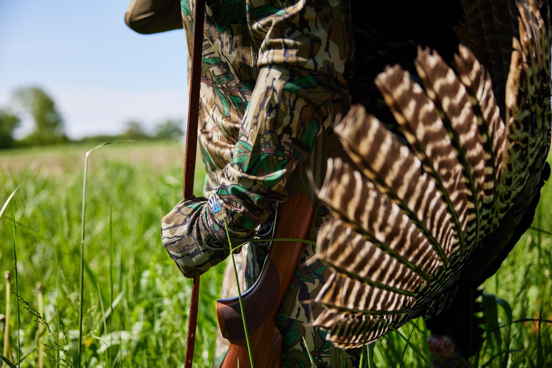 Close up of a hunter with a turkey on her back after a hunt, enjoy the best wild turkey recipes concept.