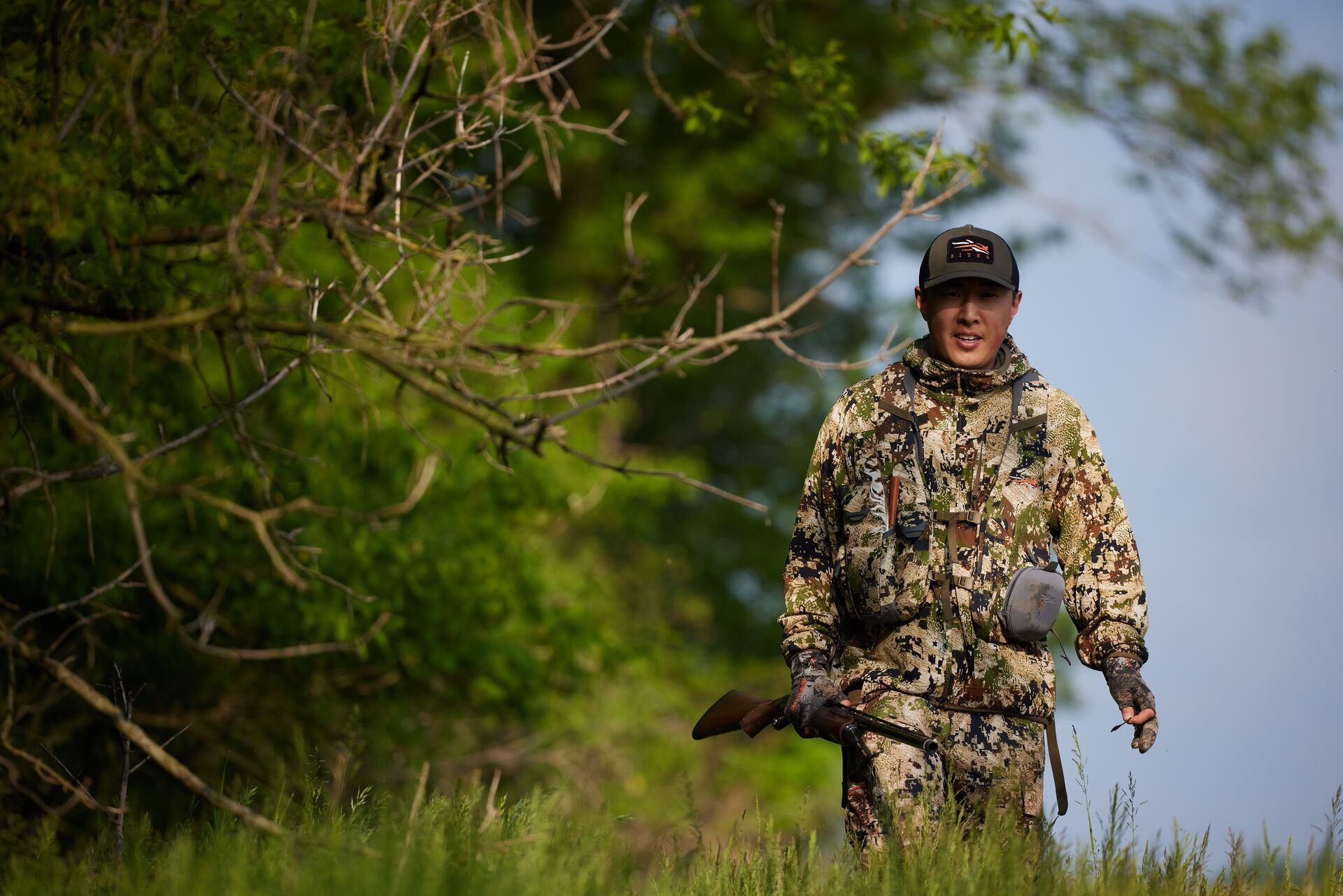 A hunter walks by a tree, Indiana hunting concept.