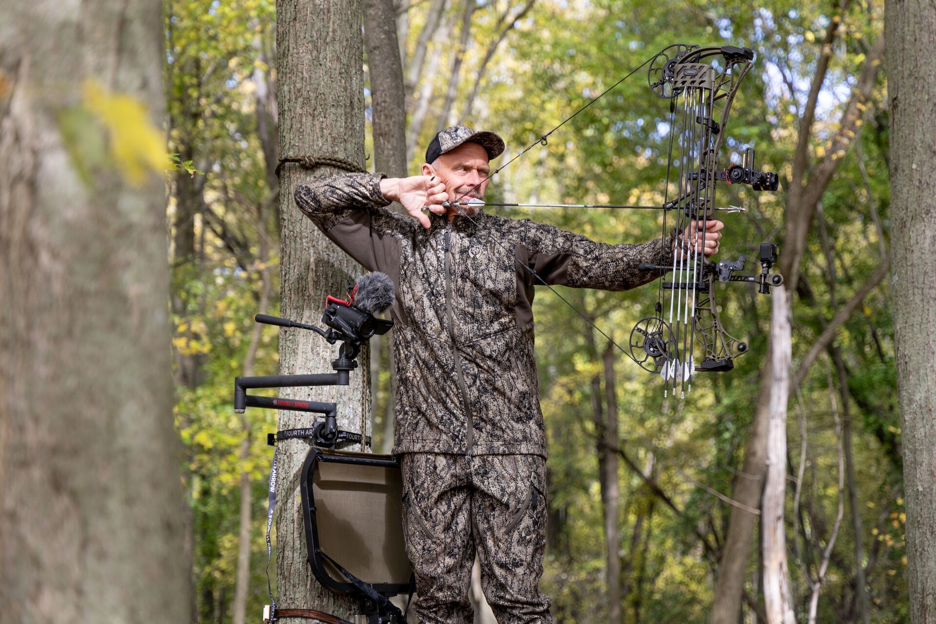 A hunter in a tree stand draws a bow, what is a broadhead concept.