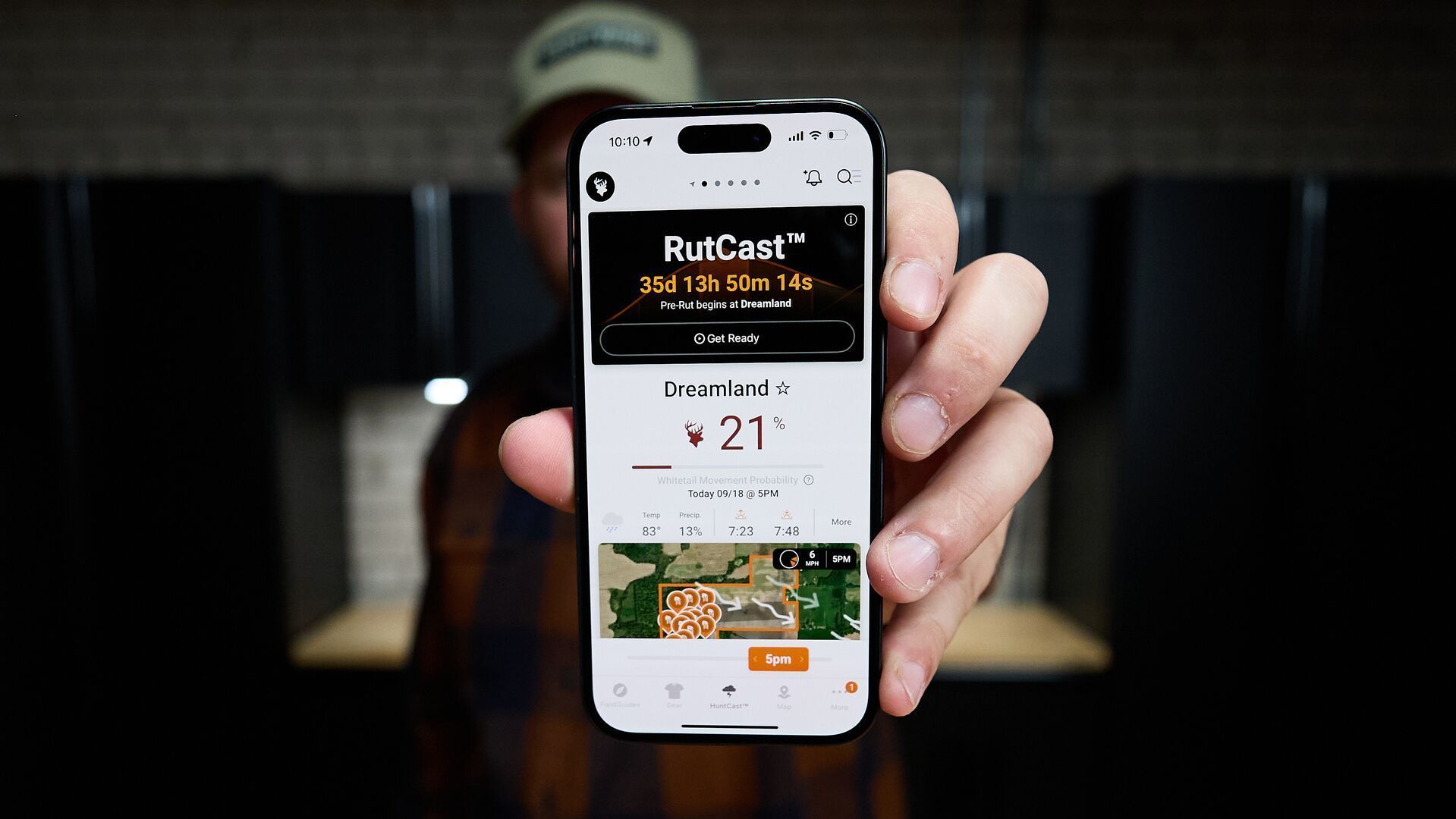 Hunter shows phone screen with HuntWise RutCast on screen.