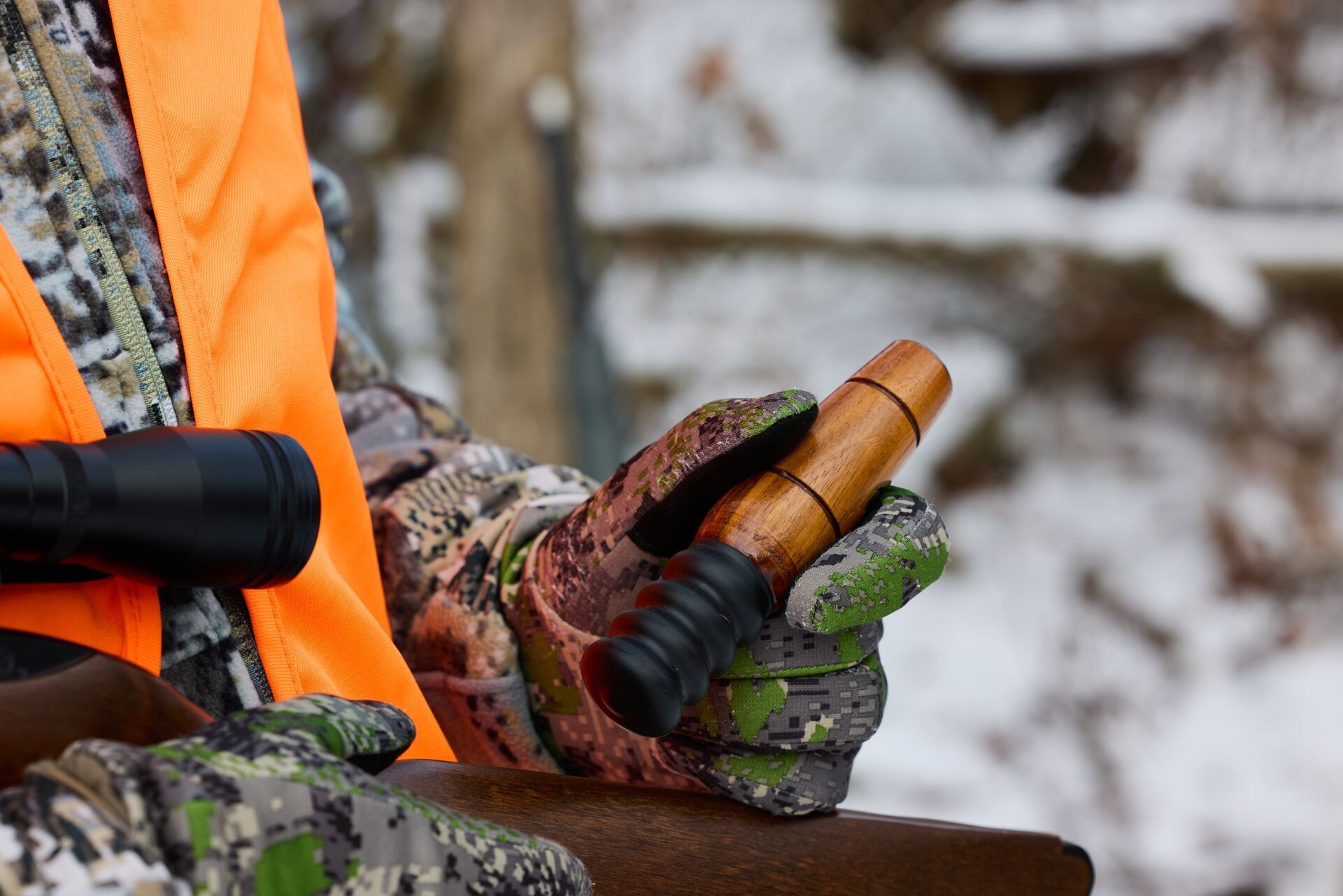 A hunter holds a game call used for hunting squirrels.