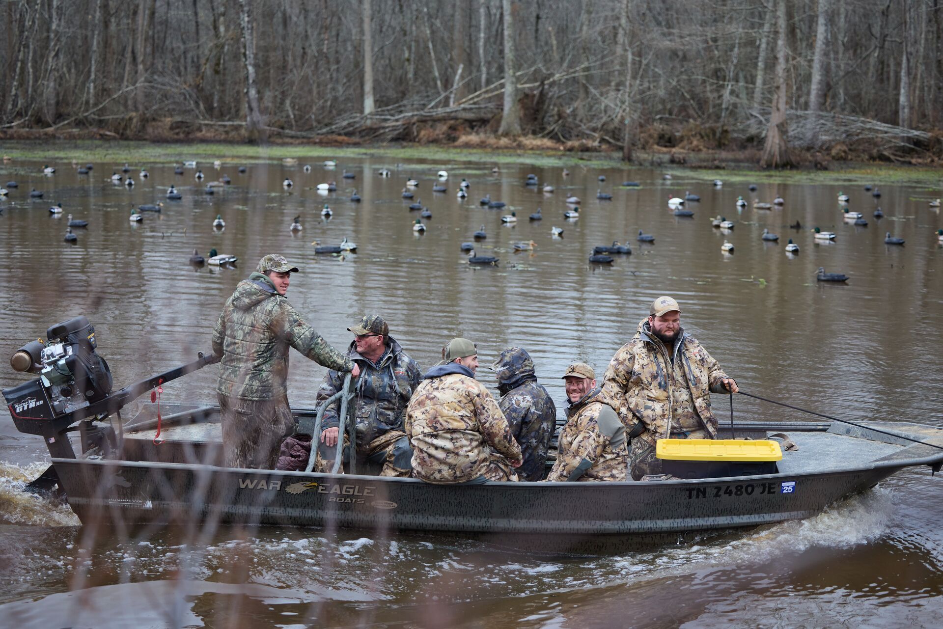 Hunters in a boat on the water for a duck hunt.