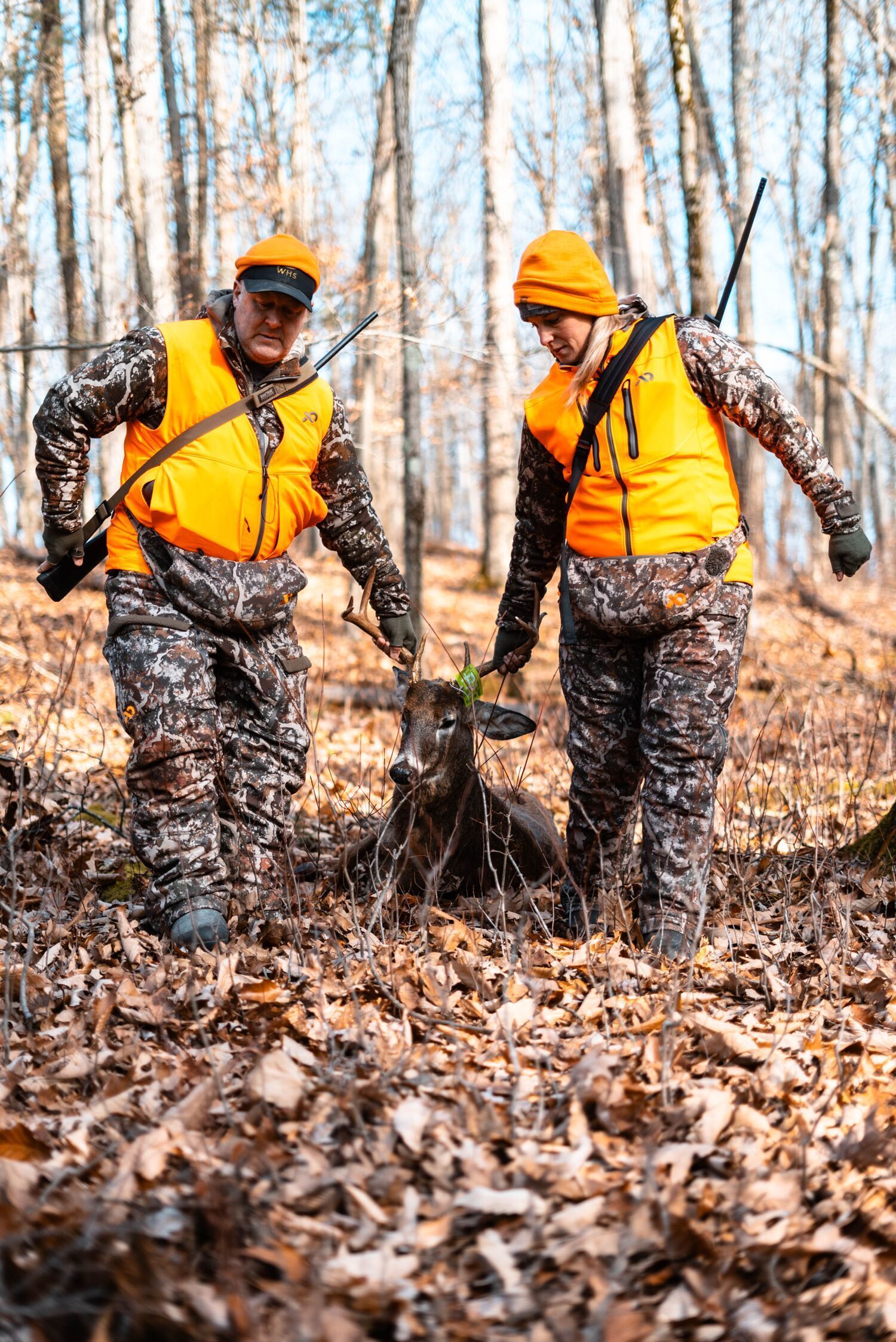 Jeff Sturgis and a hunting buddy drag a deer after a kill shot, use HuntWise concept.
