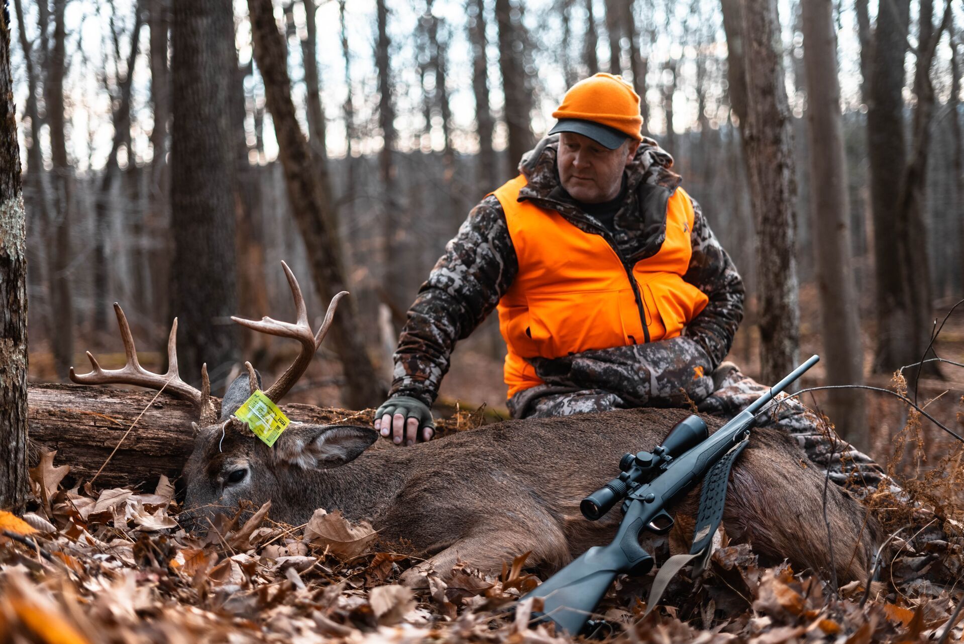 Jeff Sturgis sits with a buck kill after using HuntWise.