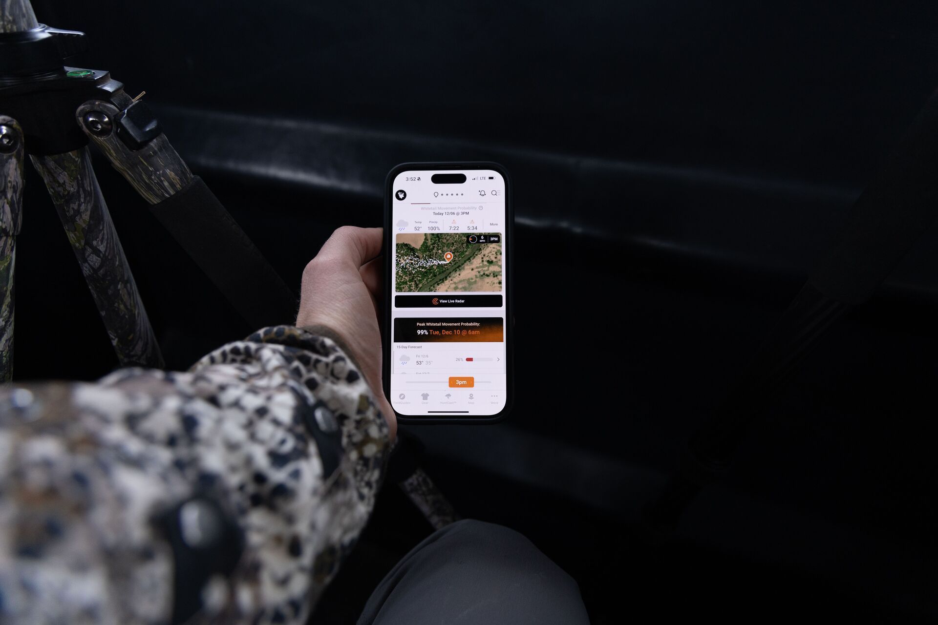 A phone shows the HuntWise hunting app in a hunter