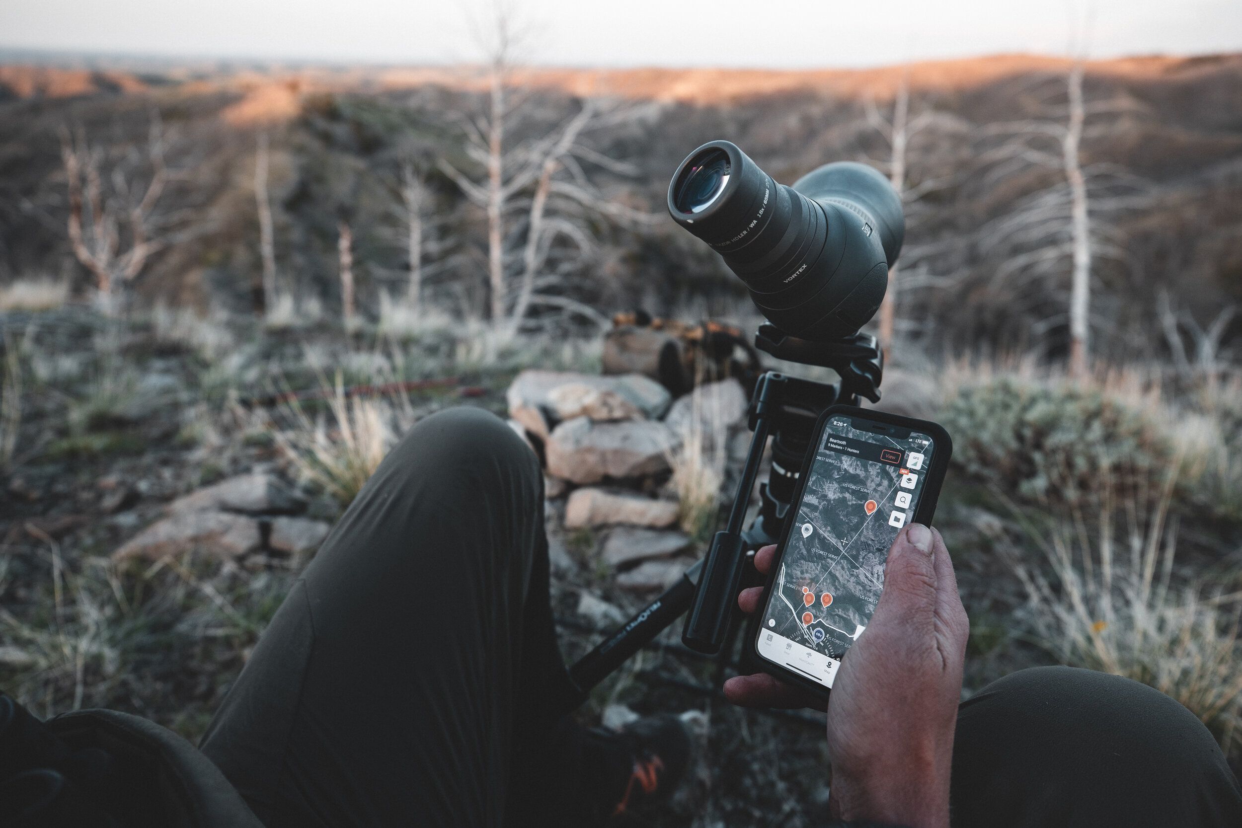 A hunter e-scouting with HuntWise, using cellular trail cams concept.