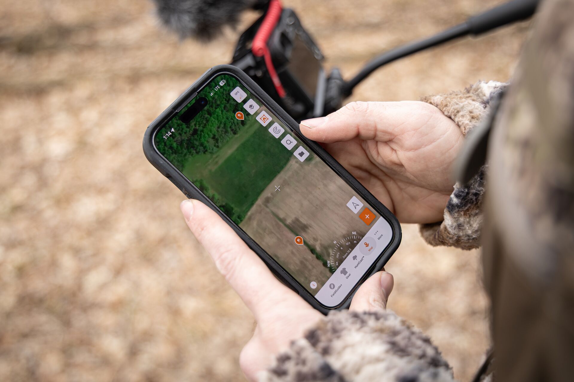 Close-up of HuntWise map on phone screen, hunting permission private land concept. 