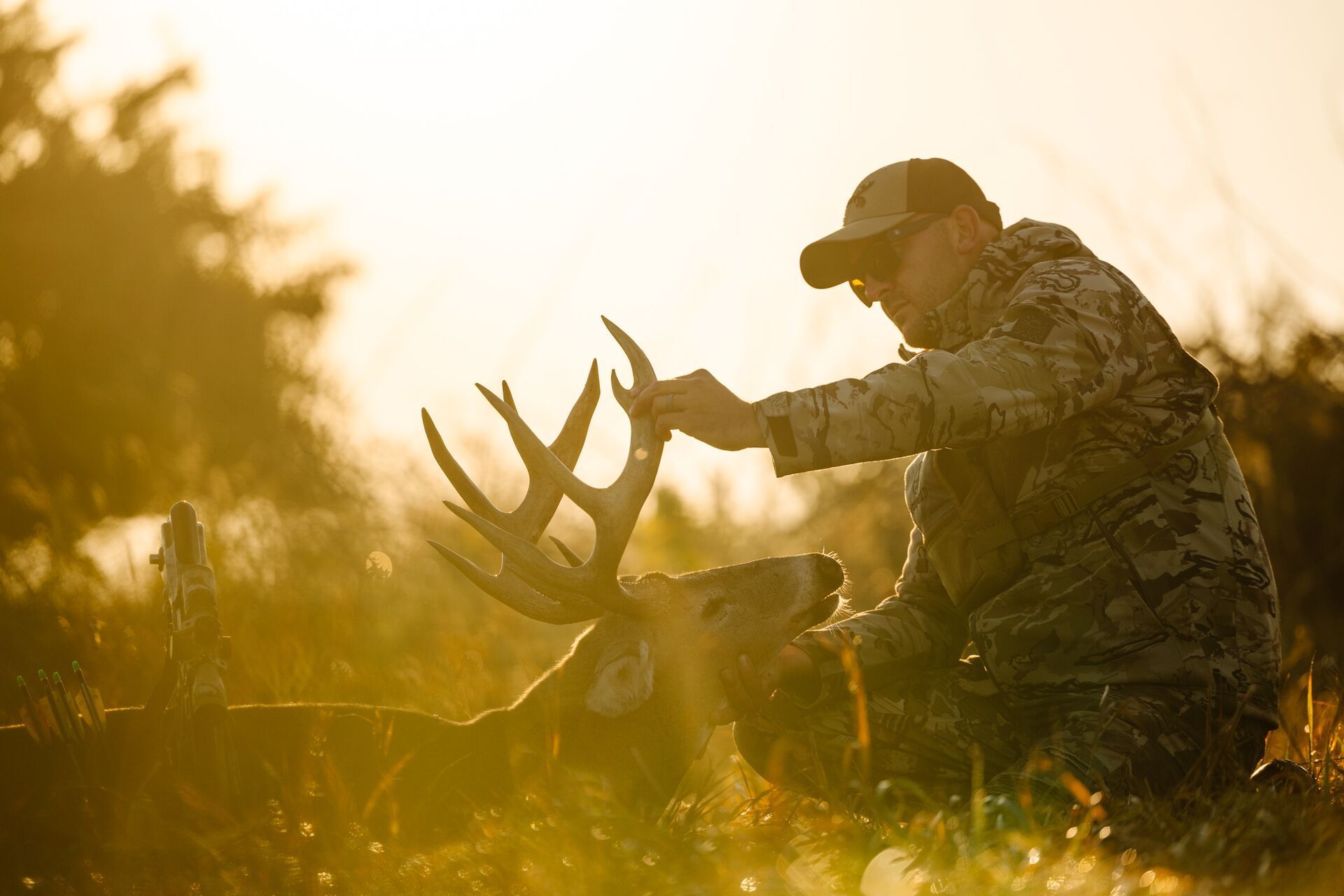 A hunter handles a whitetail buck