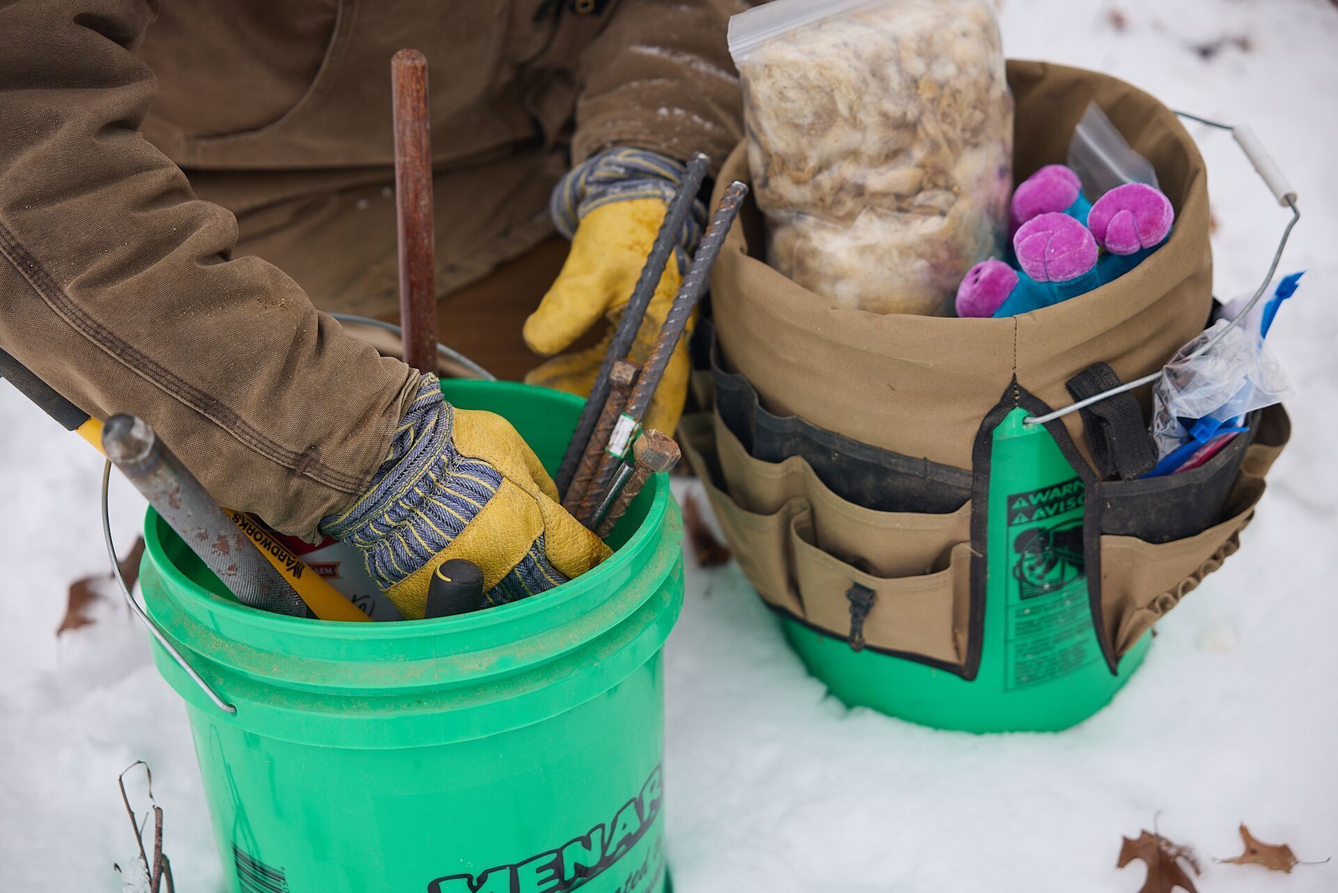 Close-up of hunter with trapping equipment in the snow.