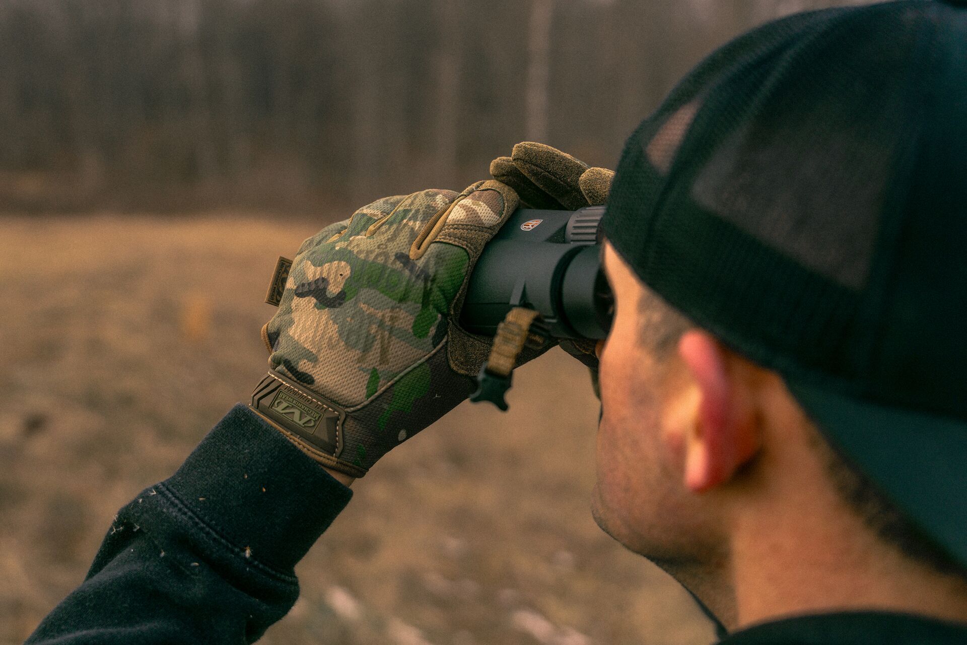 Hunter using binoculars, how to scout for pronghorn concept.