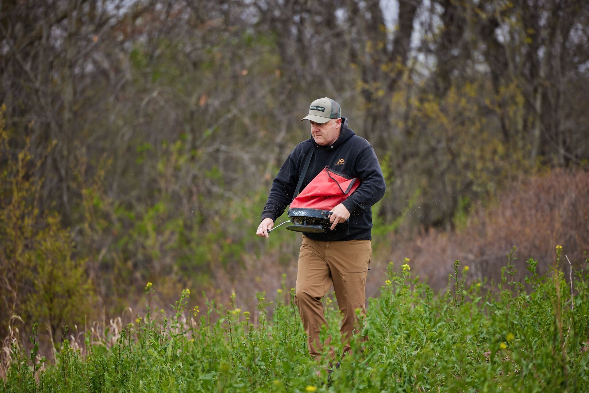 Jeff Sturgis seeds a food plot, HuntWise hunting app pro.