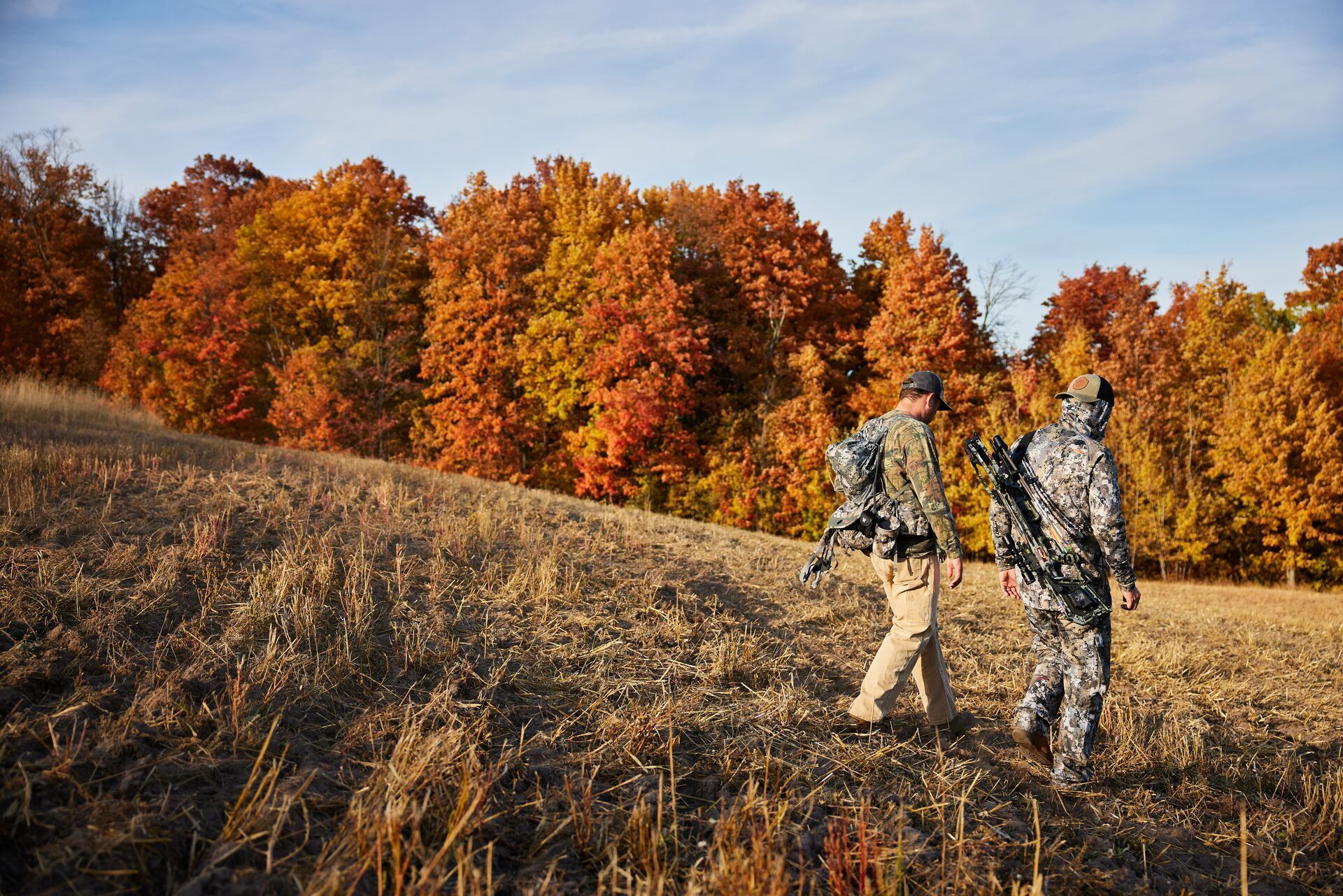 Two hunters walk downhill, how do thermals work in hunting concept.