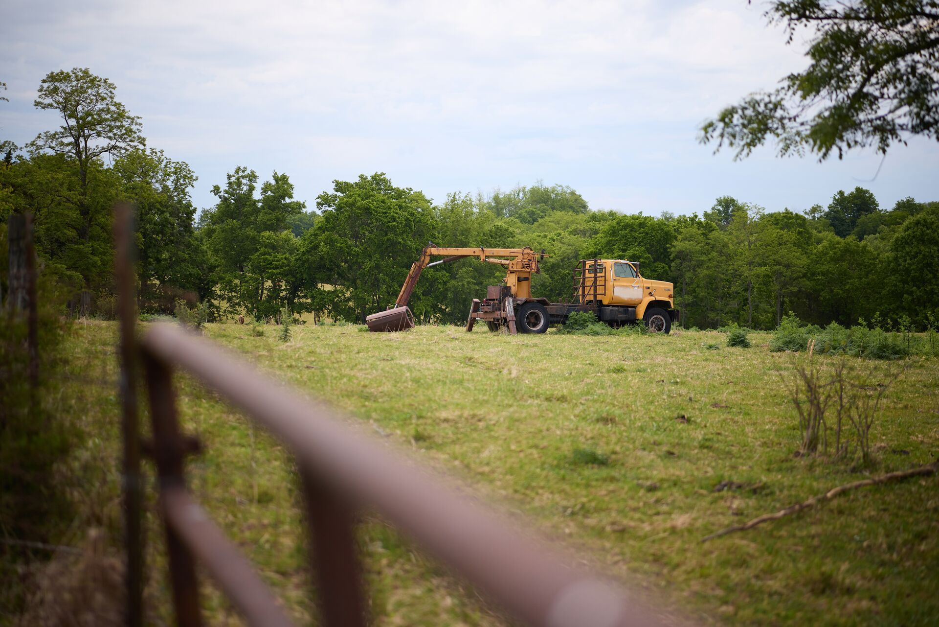 View over fence at farm equipment on land, how to ask for hunting permission concept. 