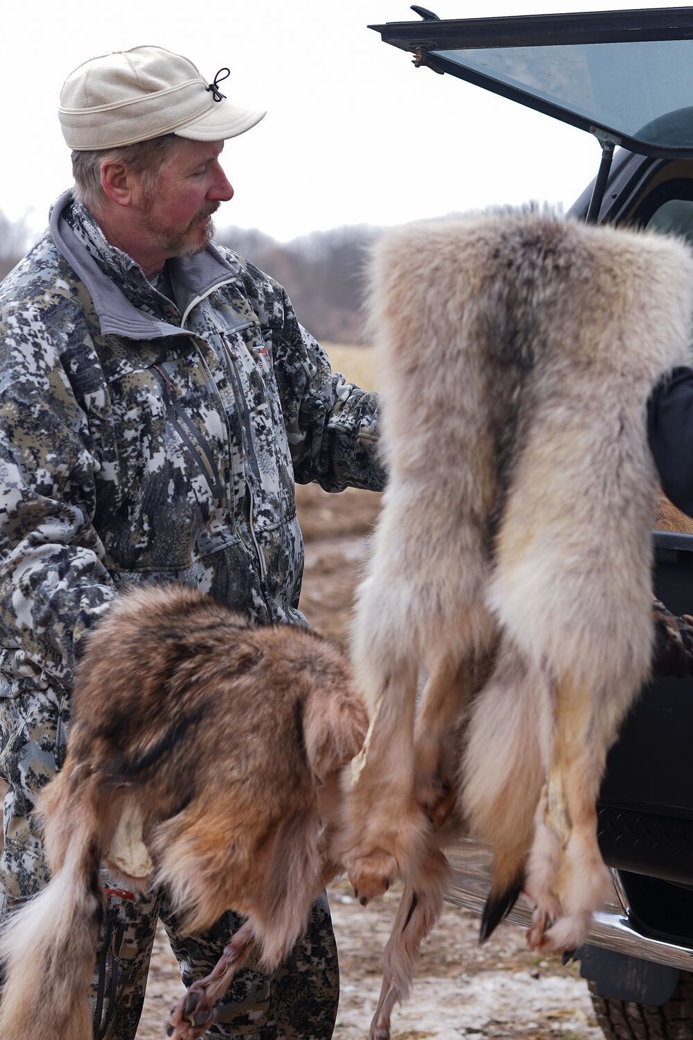 FGBLOG hunter with coyote pelts.jpeg