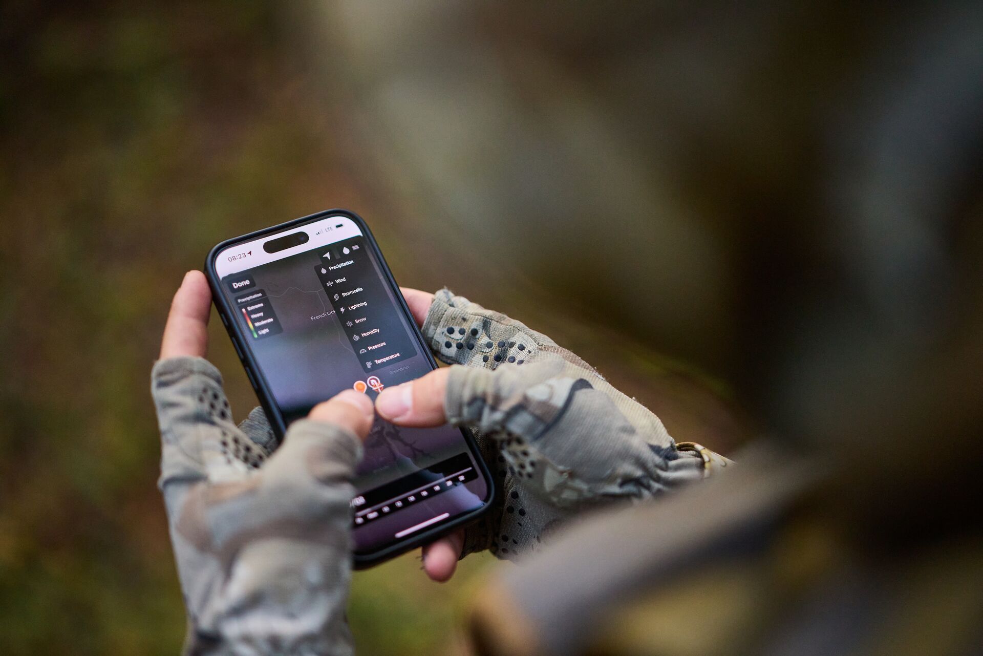 Close-up of hunter using HuntWise on phone.