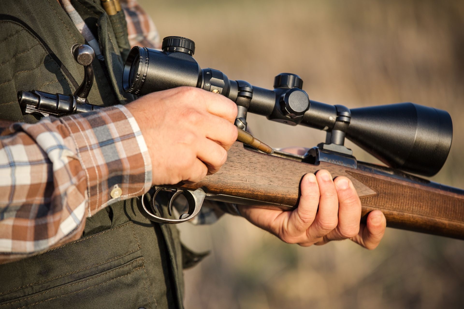 Close-up of loading bolt action rifle, types of hunting rifles concept.