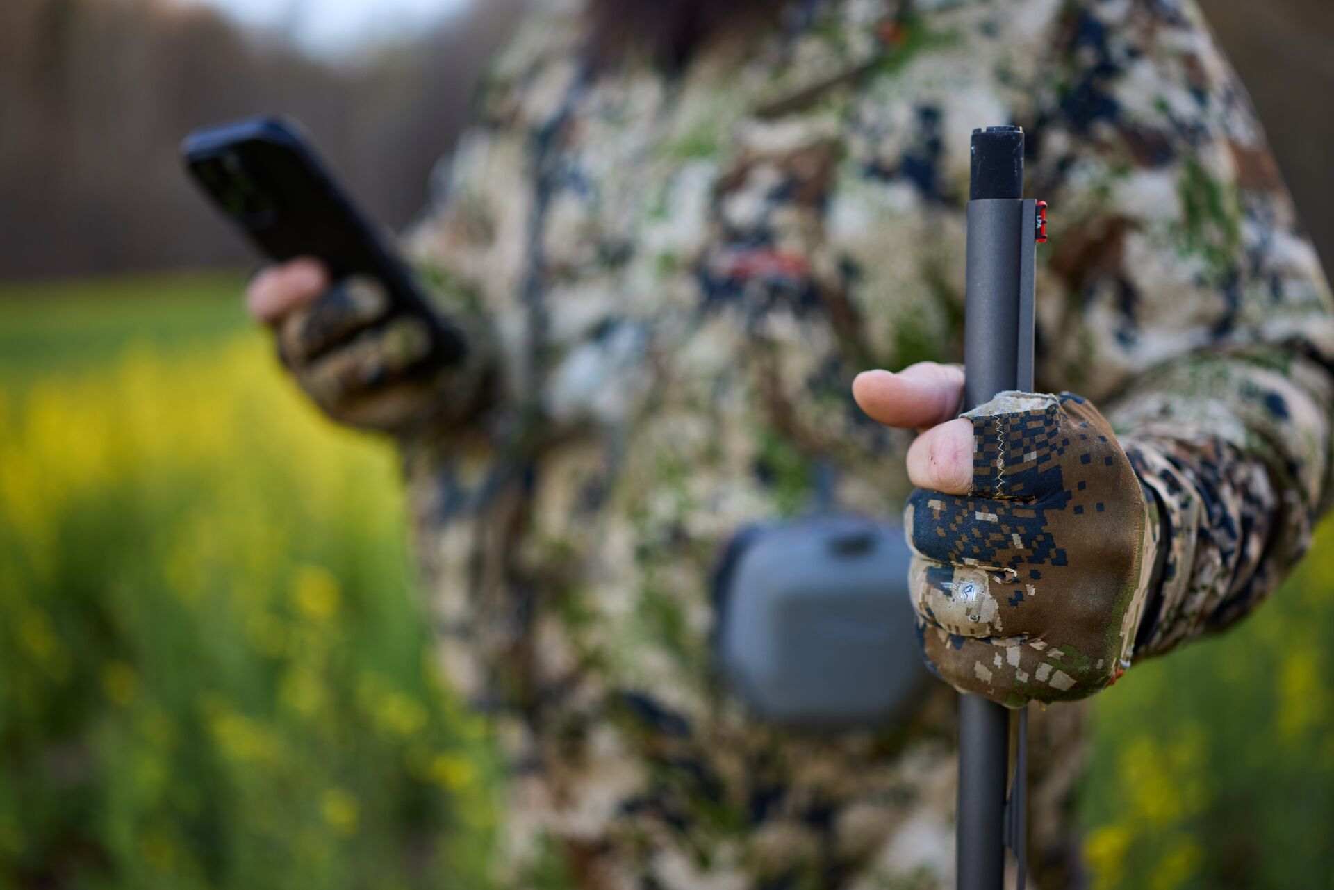 Close-up of hunter in turkey gear with shotgun, spring turkey gear concept.