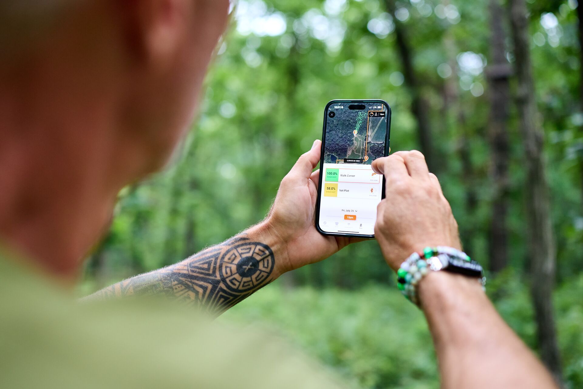 Hunter John Dudley using HuntWise in the woods.