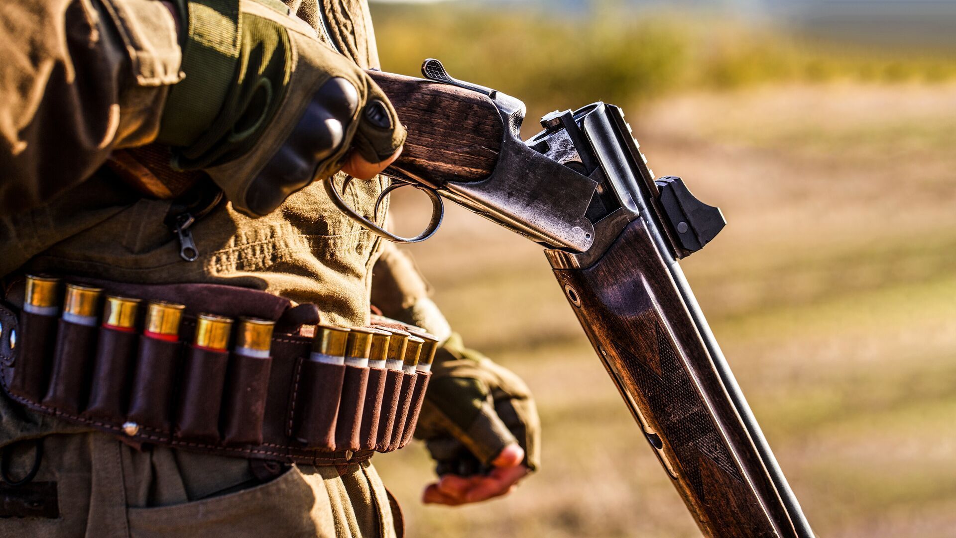 Close-up of hunter with break-action shotgun.