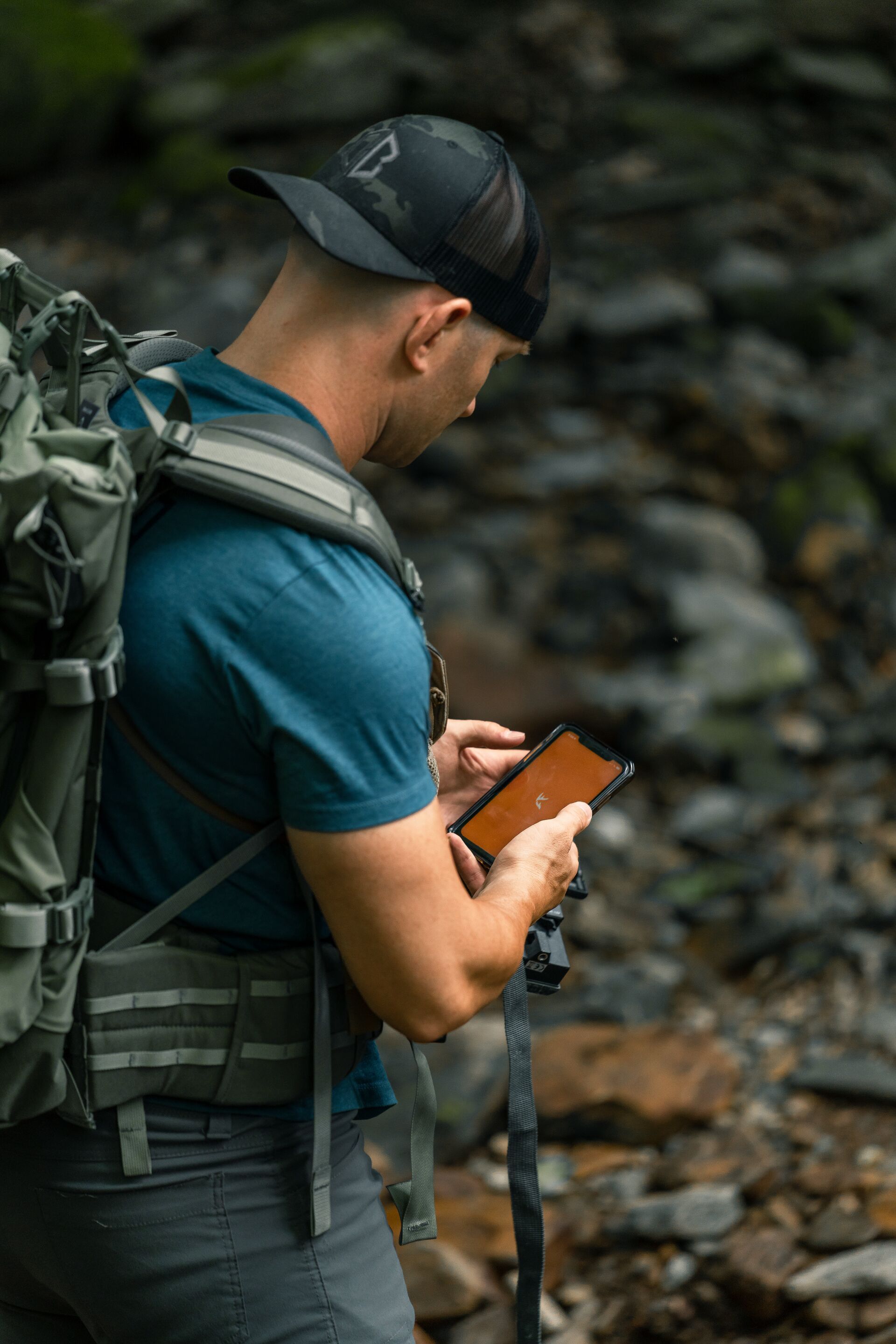 Hunter scouting for land using HuntWise on phone, WMA hunting concept.