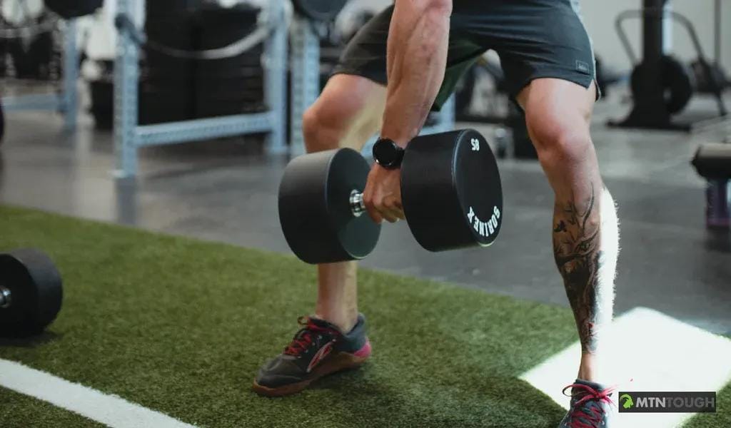 Close-up of a man holding a dumbbell, hunting exercises concept.