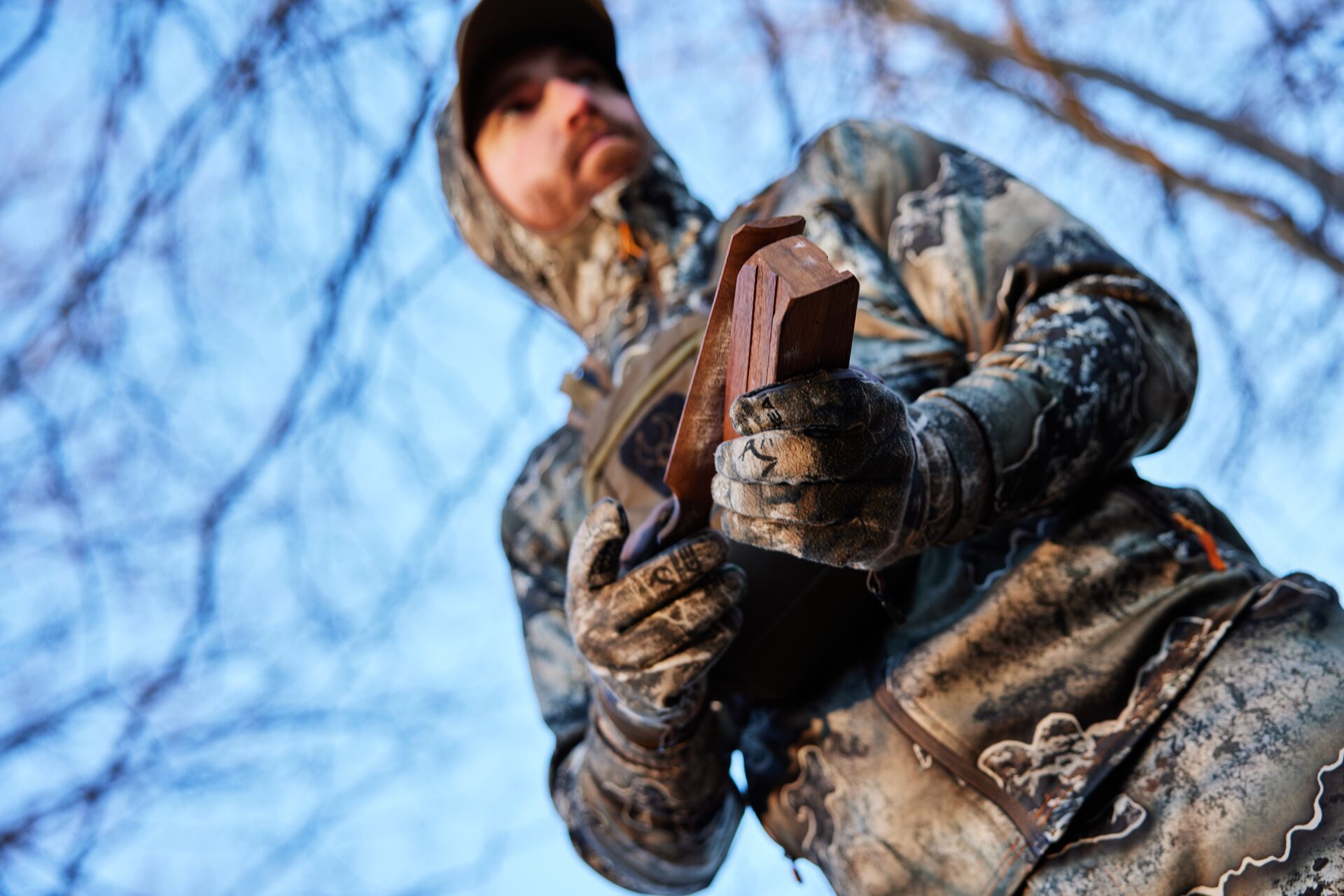 Hunter using a a turkey box call.