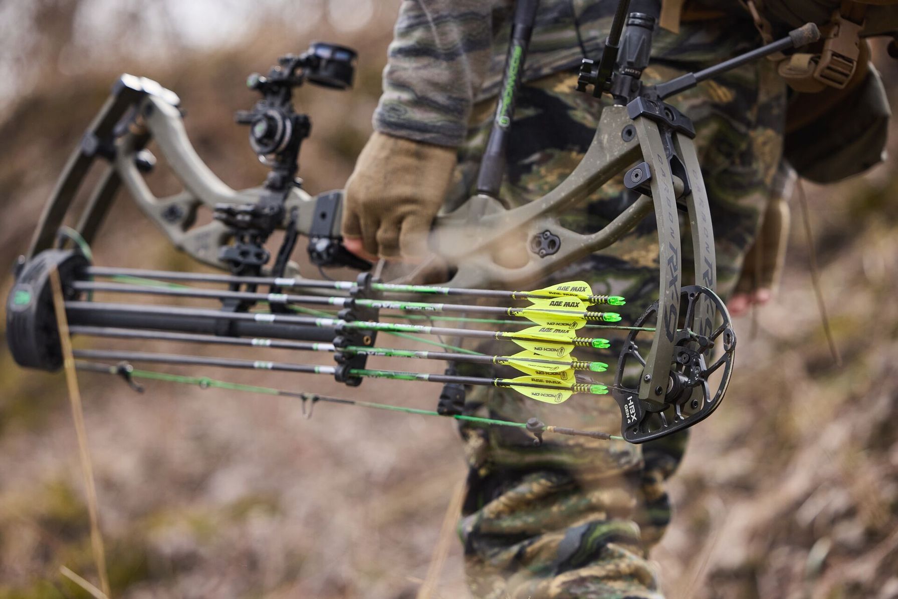 Close-up of hunter carrying bow, walk-in hunting access in Oklahoma concept. 