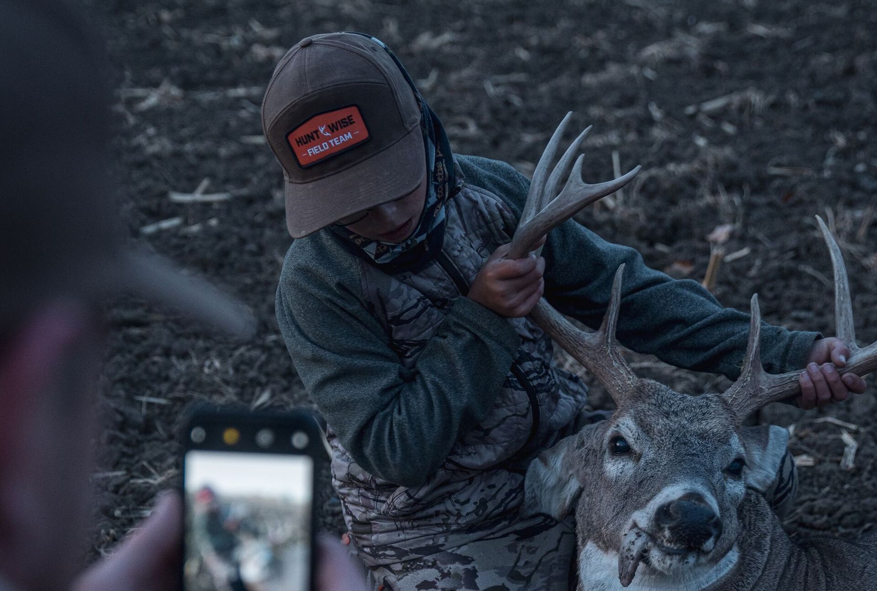 A young hunter has his picture taken with a buck after tagging out, Kentucky hunting concept.