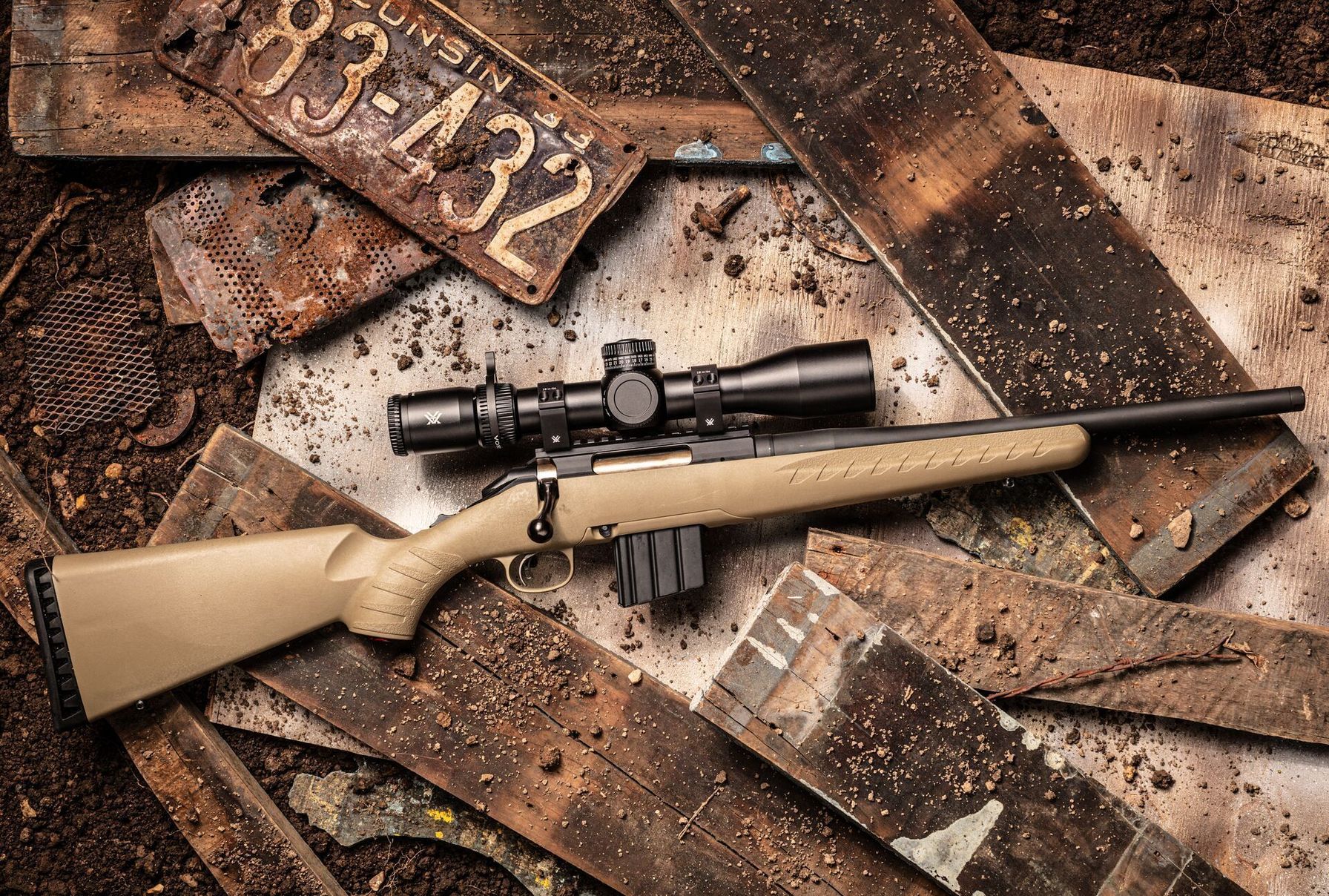 A bolt action rifle on the ground, lever action v bolt action rifles concept.