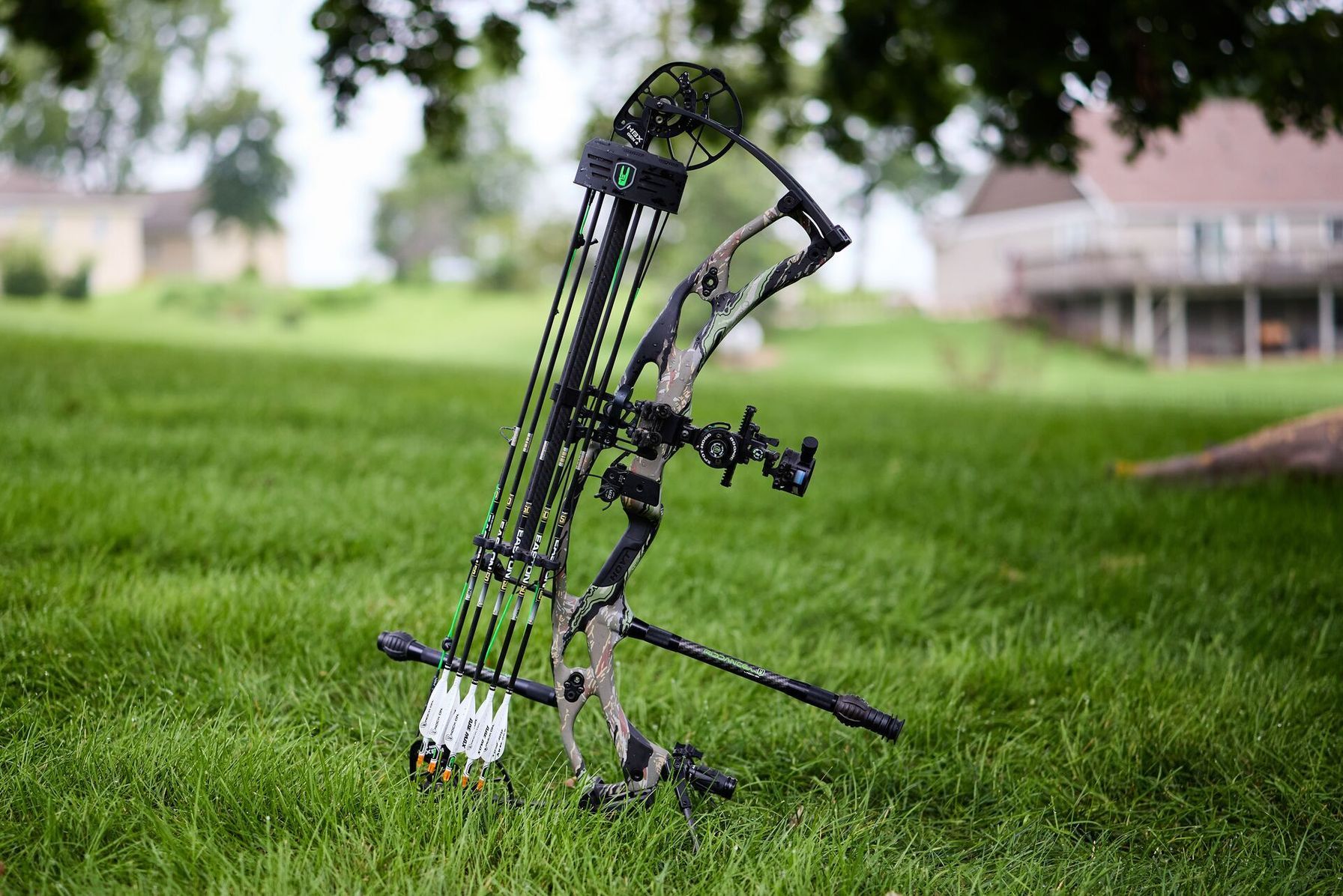 Compound bow propped up in the grass.
