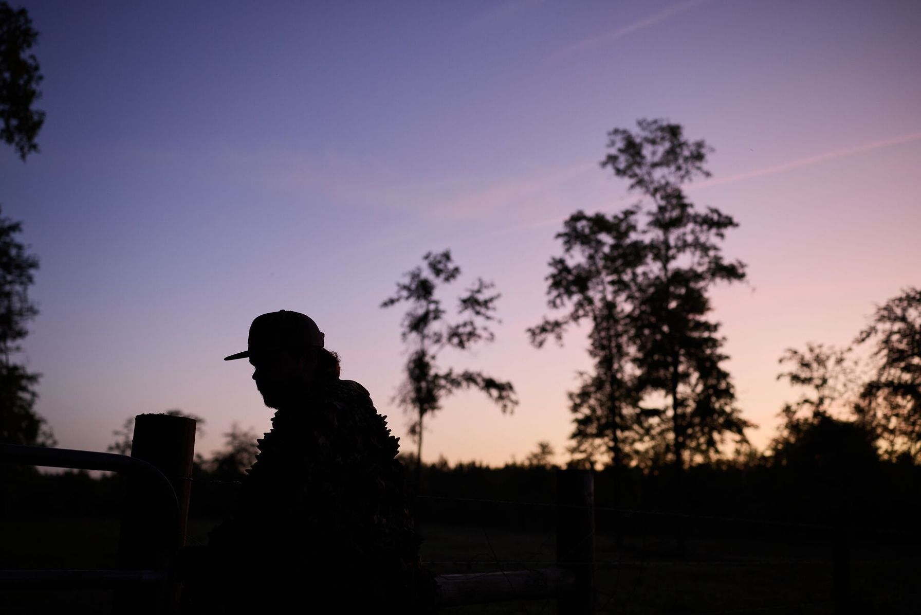Silhouette of a hunter, represents hog hunting at night.