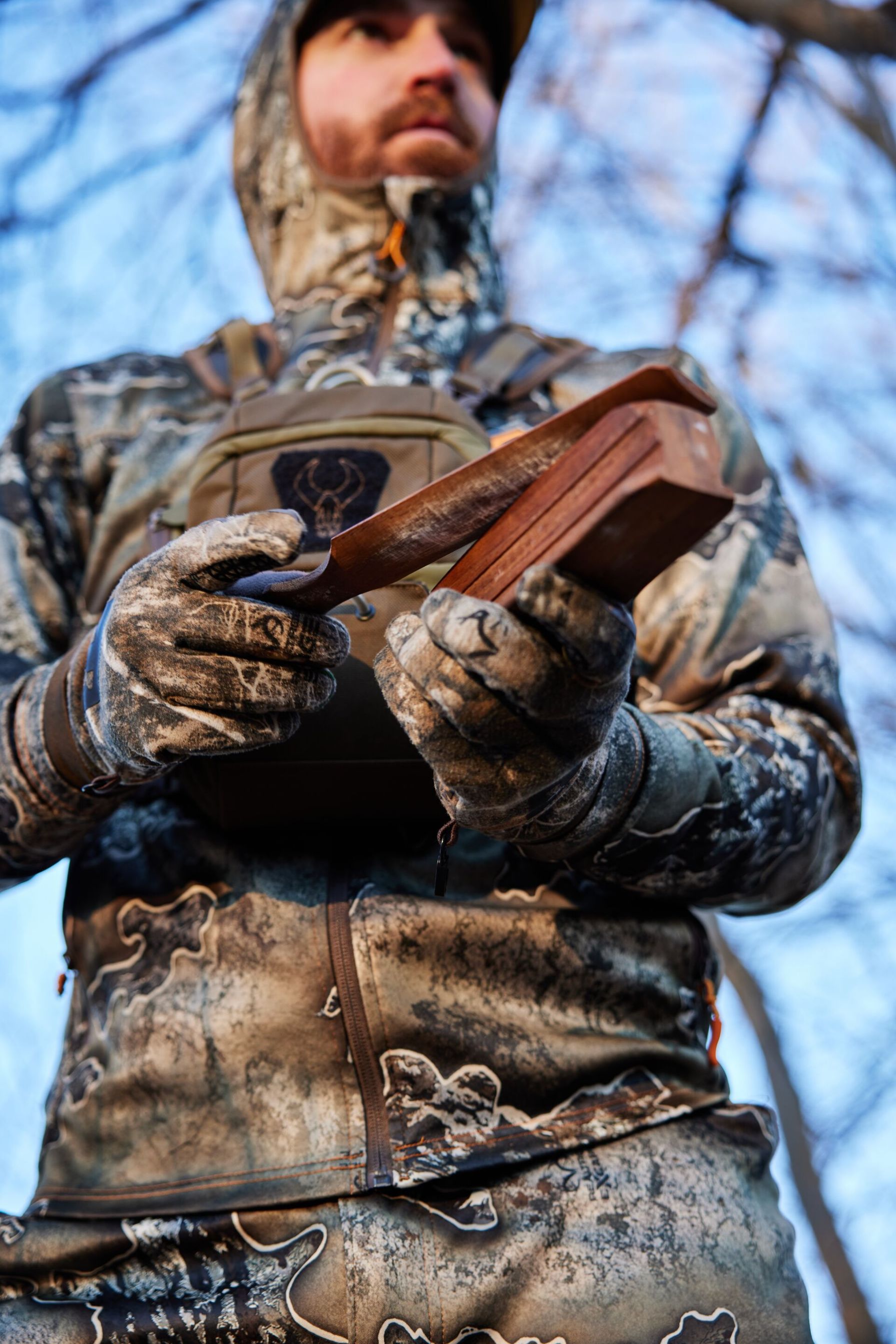 Close-up of a hunter using a turkey box call, turkey calling basics concept.