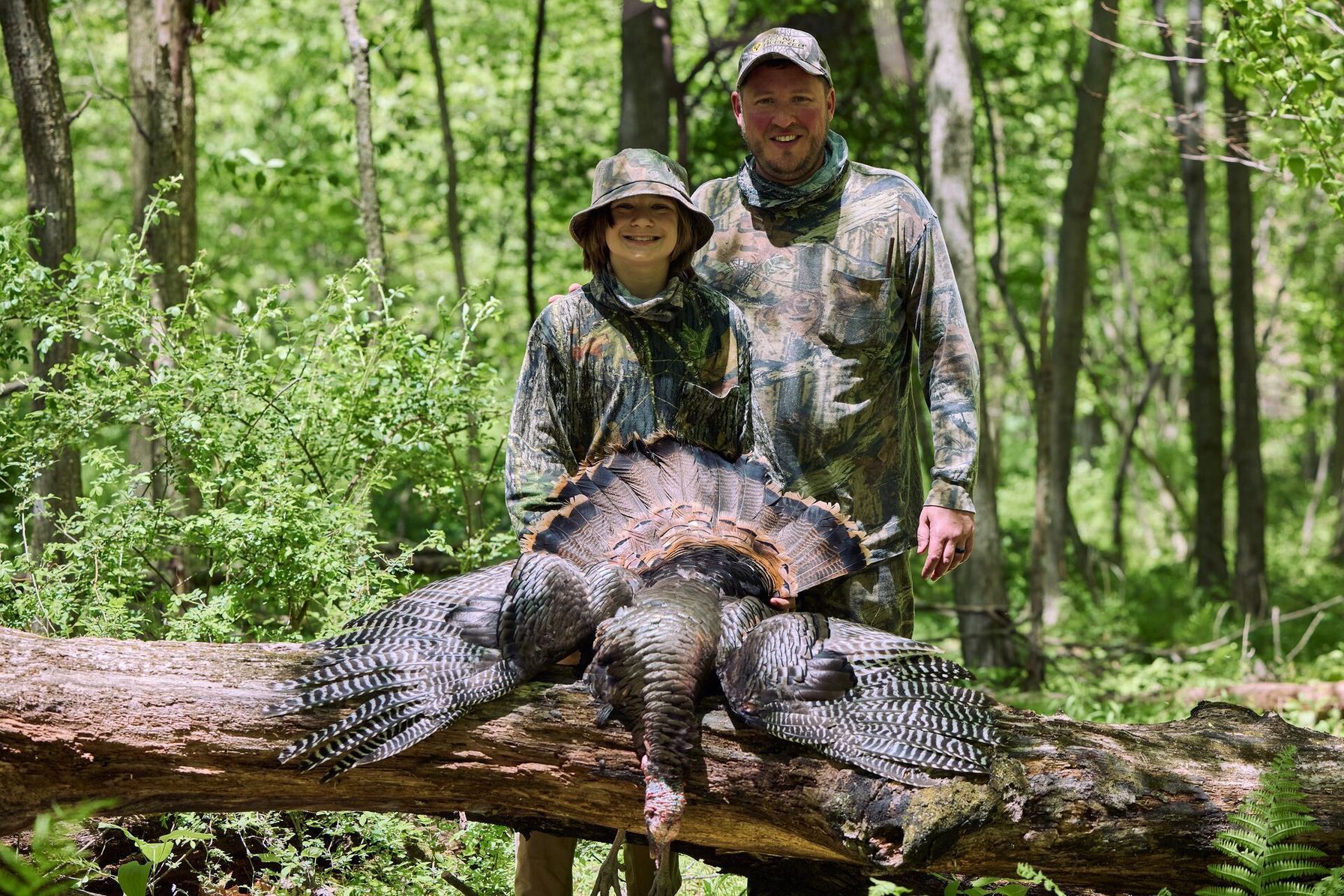 A boyy and man with a turkey after a Florida turkey hunt.