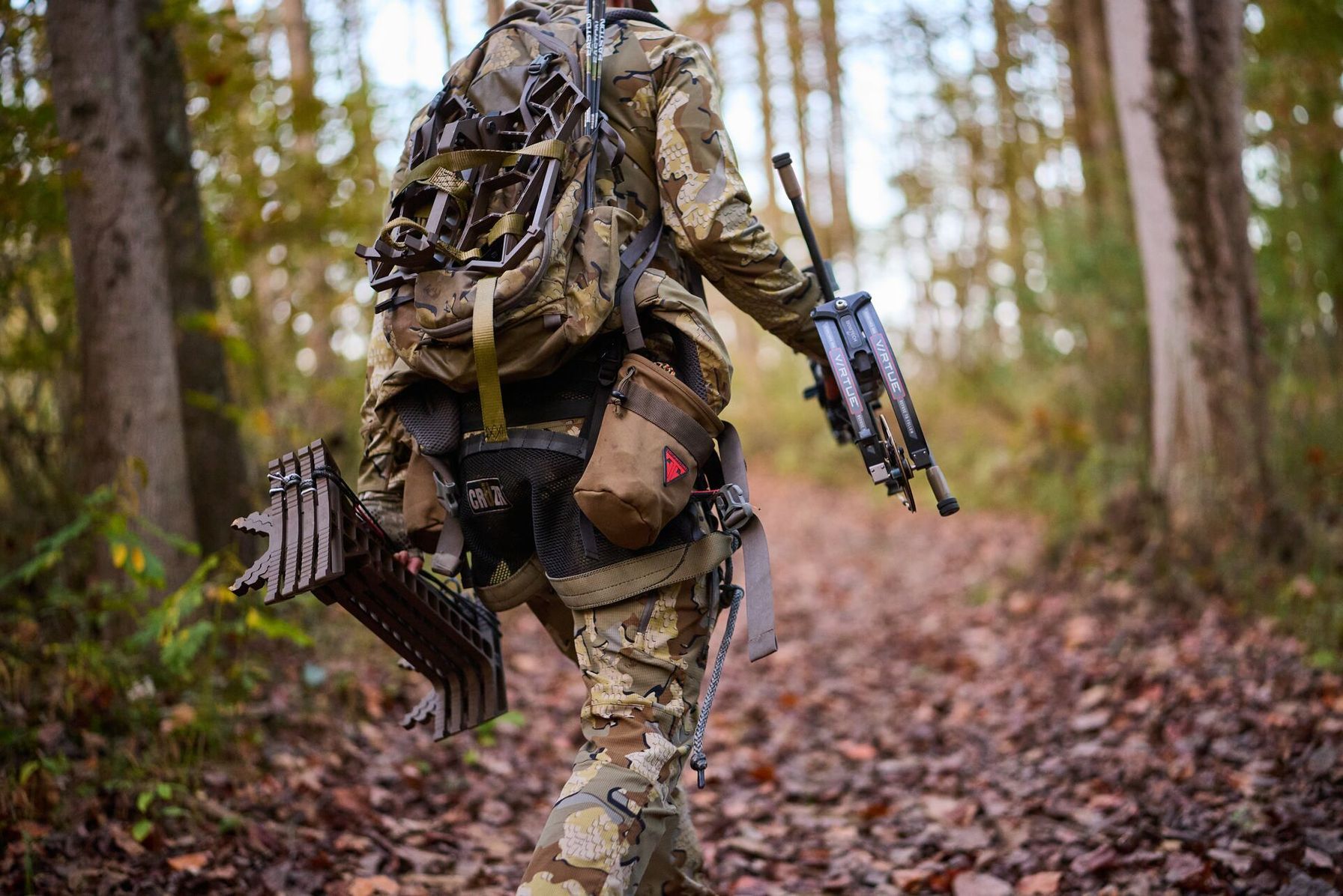Hunter in camo carries gear into woods, find walk-in hunting access in Texas concept.