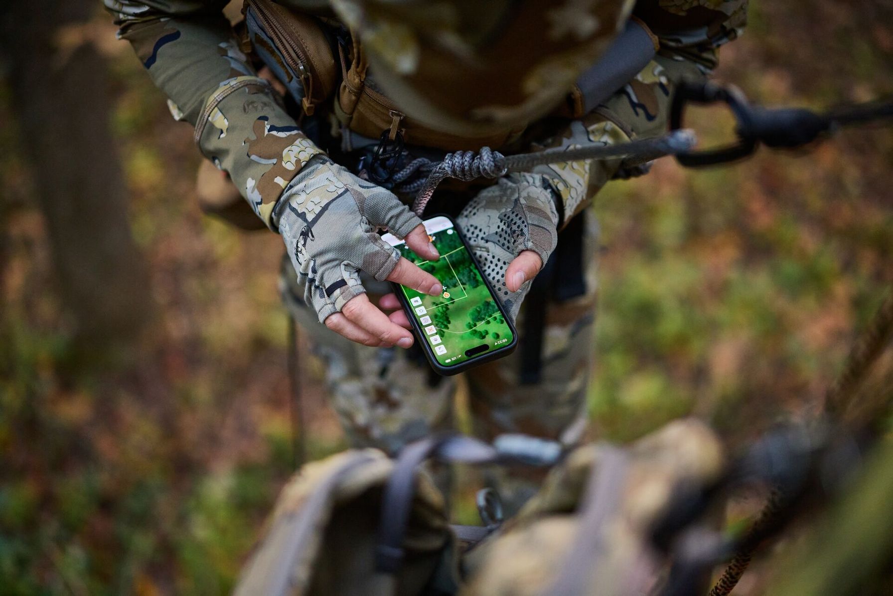 Overhead view of hunter in tree using HuntWise, hunting app with property lines concept.