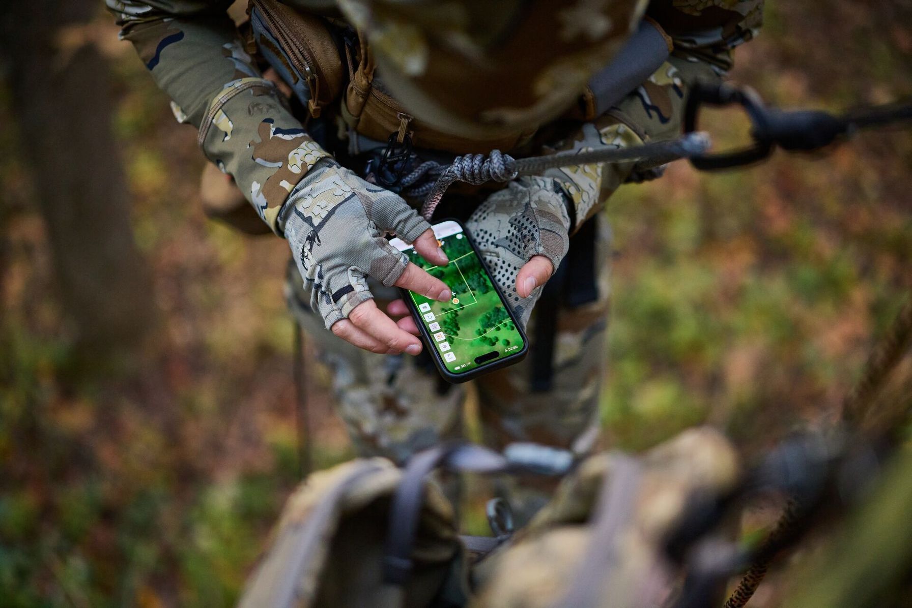Overhead view of hunter in tree using HuntWise, hunting app with property lines concept.