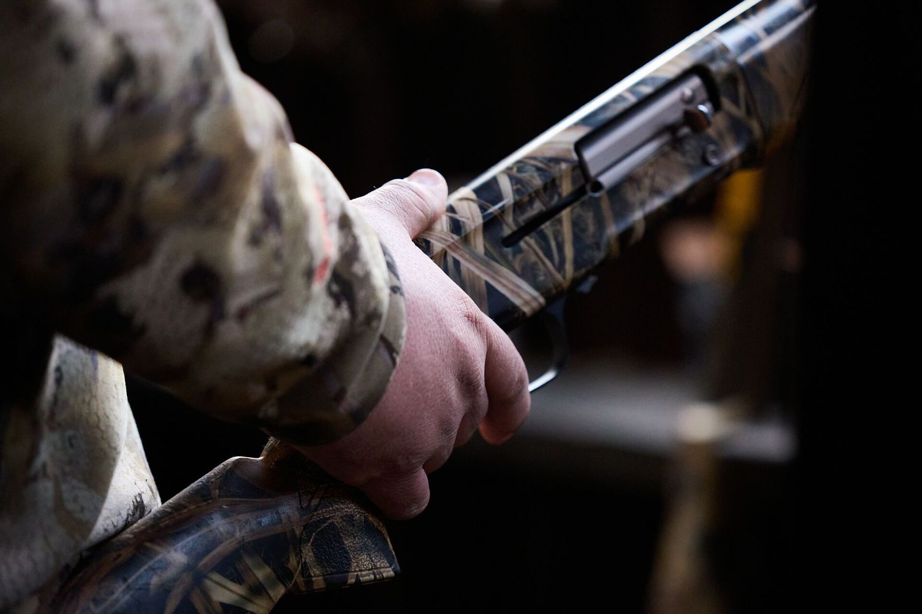 FGBLOG hunter holds camo shotgun.jpeg